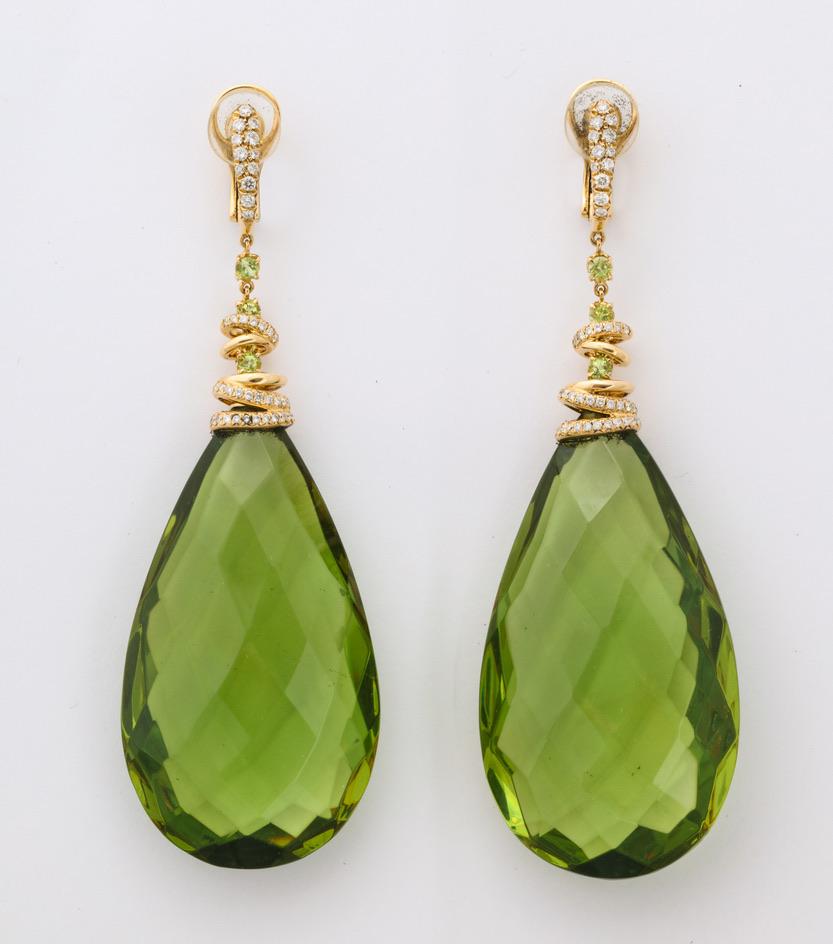 Go big or go home!  These will certainly be the boldest earrings at the ball, and also likely the most beautiful.  The stylish 18kt yellow gold tops are set with diamonds and peridot as they spiral down to the incredible pear shape faceted amber