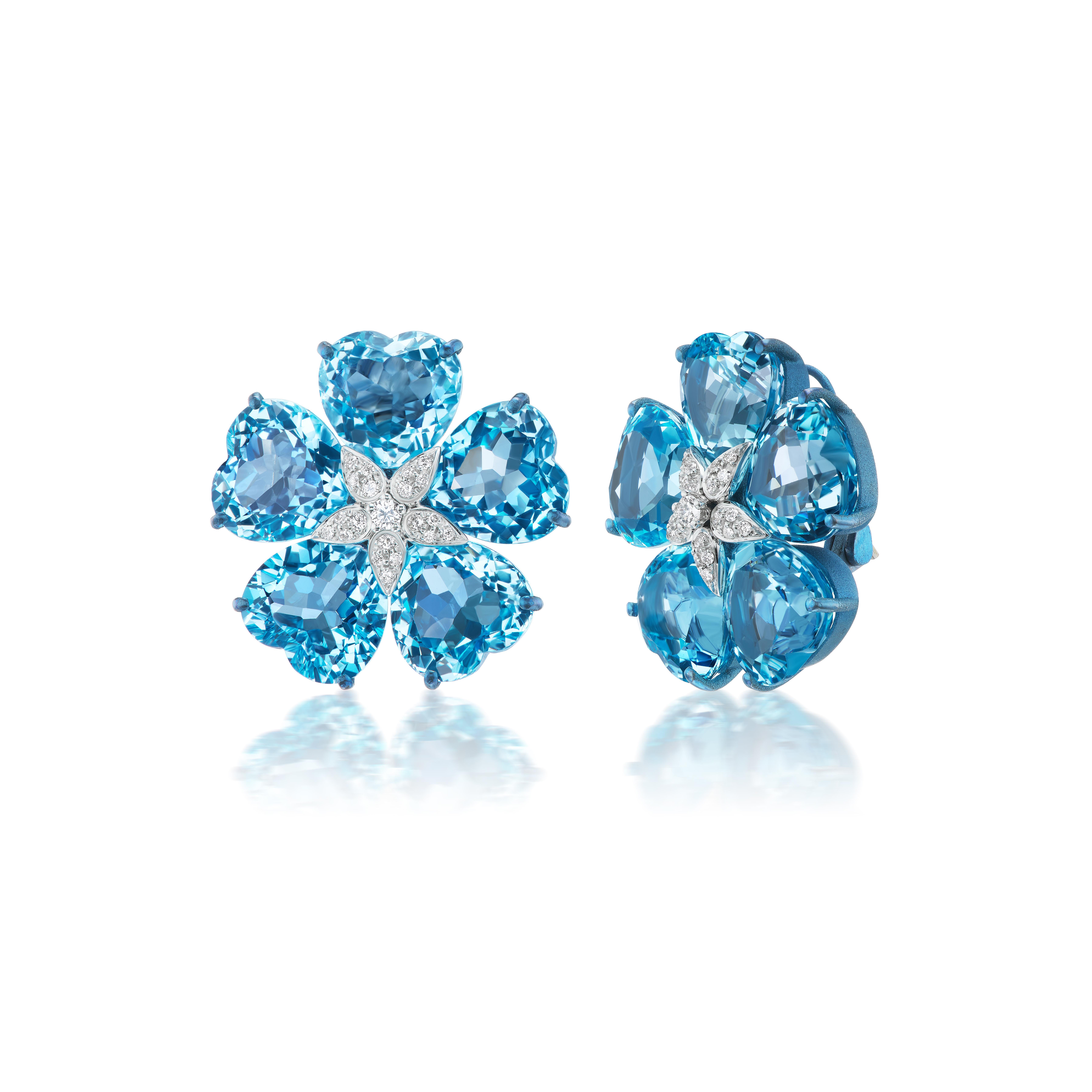Each of these exquisite earrings features five heart-shaped blue topaz around a central cluster of diamonds. The brilliant blue hue of the topaz is beautifully complemented by sparkling diamonds, creating a mesmerizing interplay of light and color.