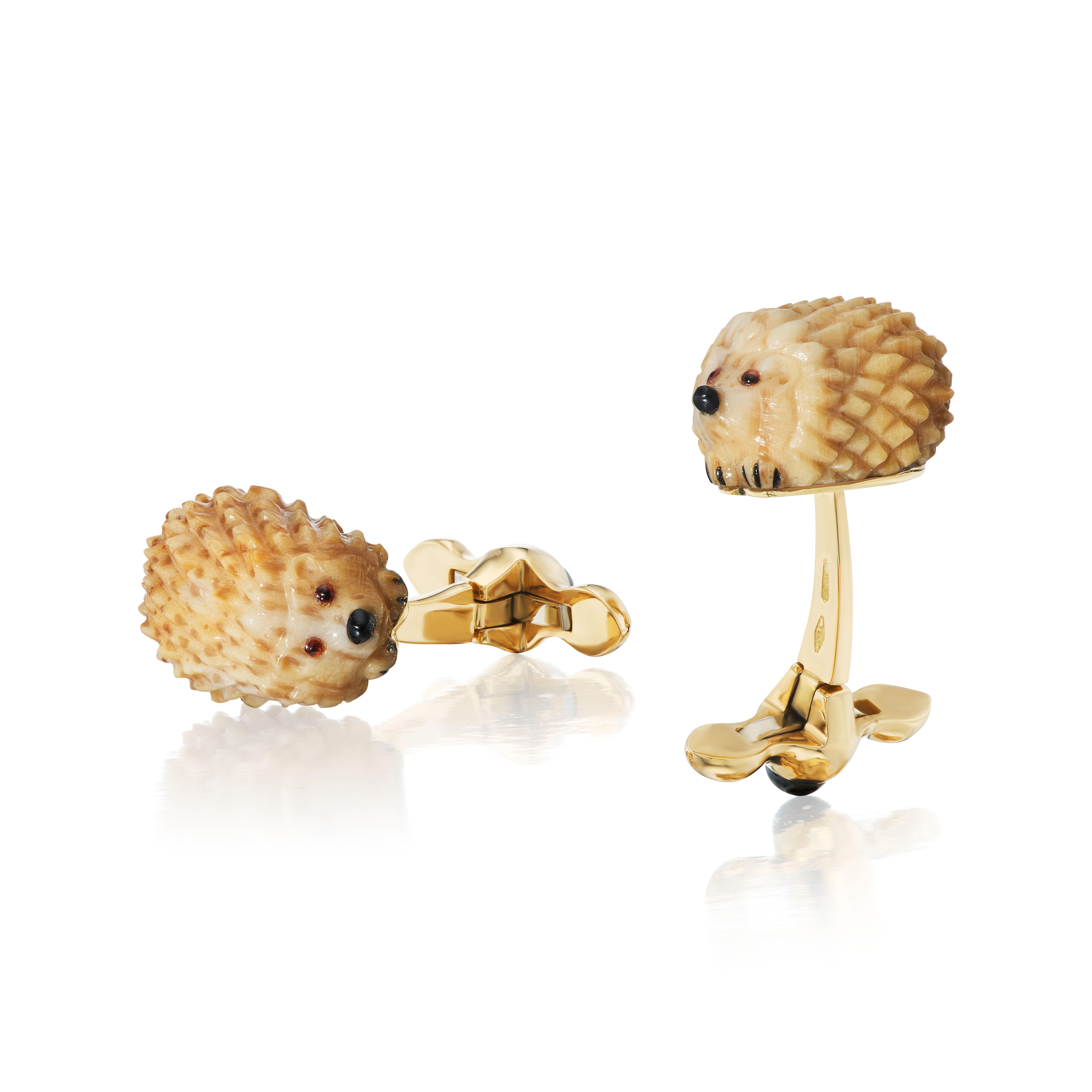 These hedgehogs are carved from a unique piece of fossilized palm tree, so each pair is always one of a kind.  The eyes are made from rock crystal with a touch of enamel behind them and the noses are carved from onyx.  Further details are in black