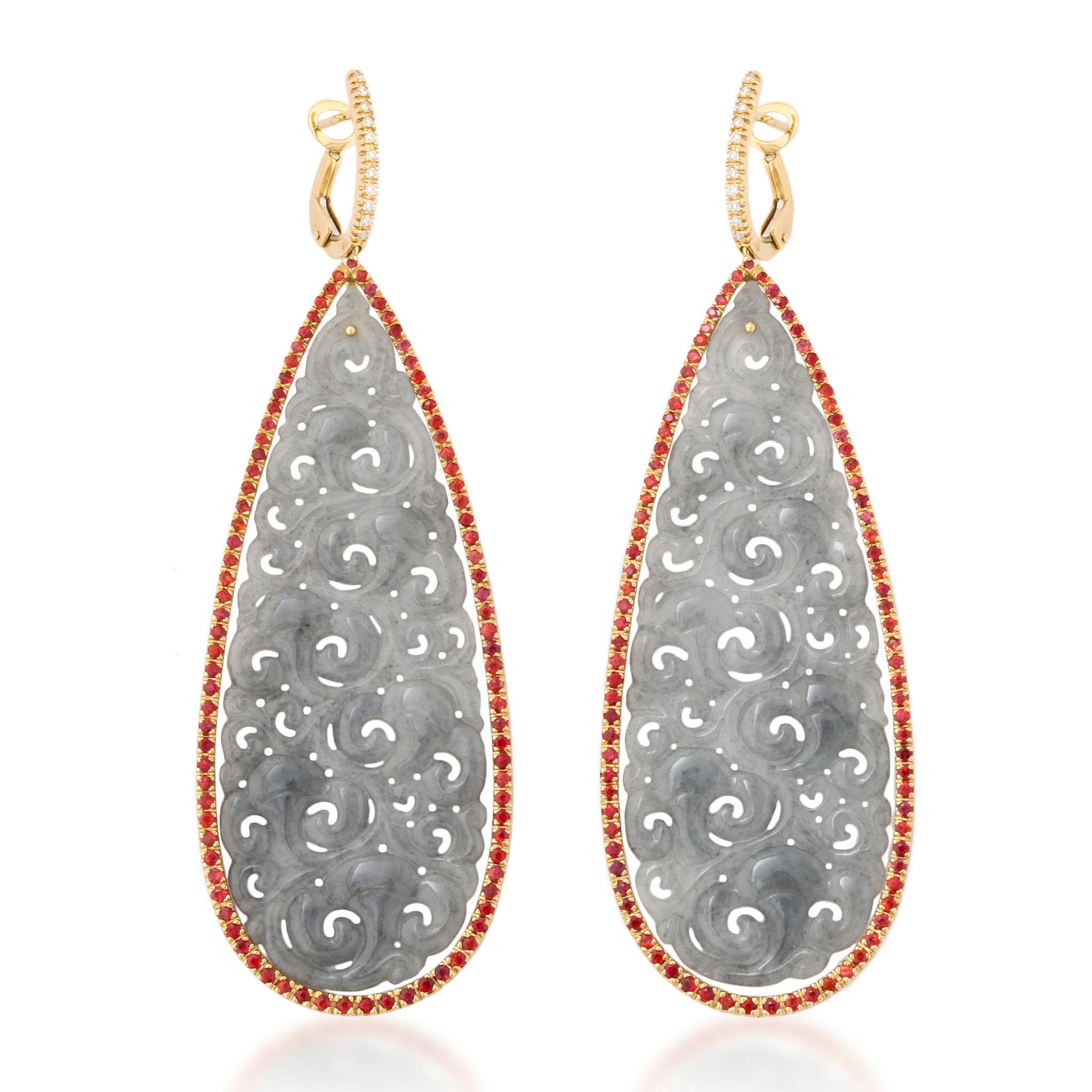 Dramatic and bold 18kt gold carved icy gray jade earrings, meticulously handcrafted in Italy. The unique design features vibrant orange sapphires and scintillating diamonds, delicately set to frame the perfectly matched and expertly carved icy jade