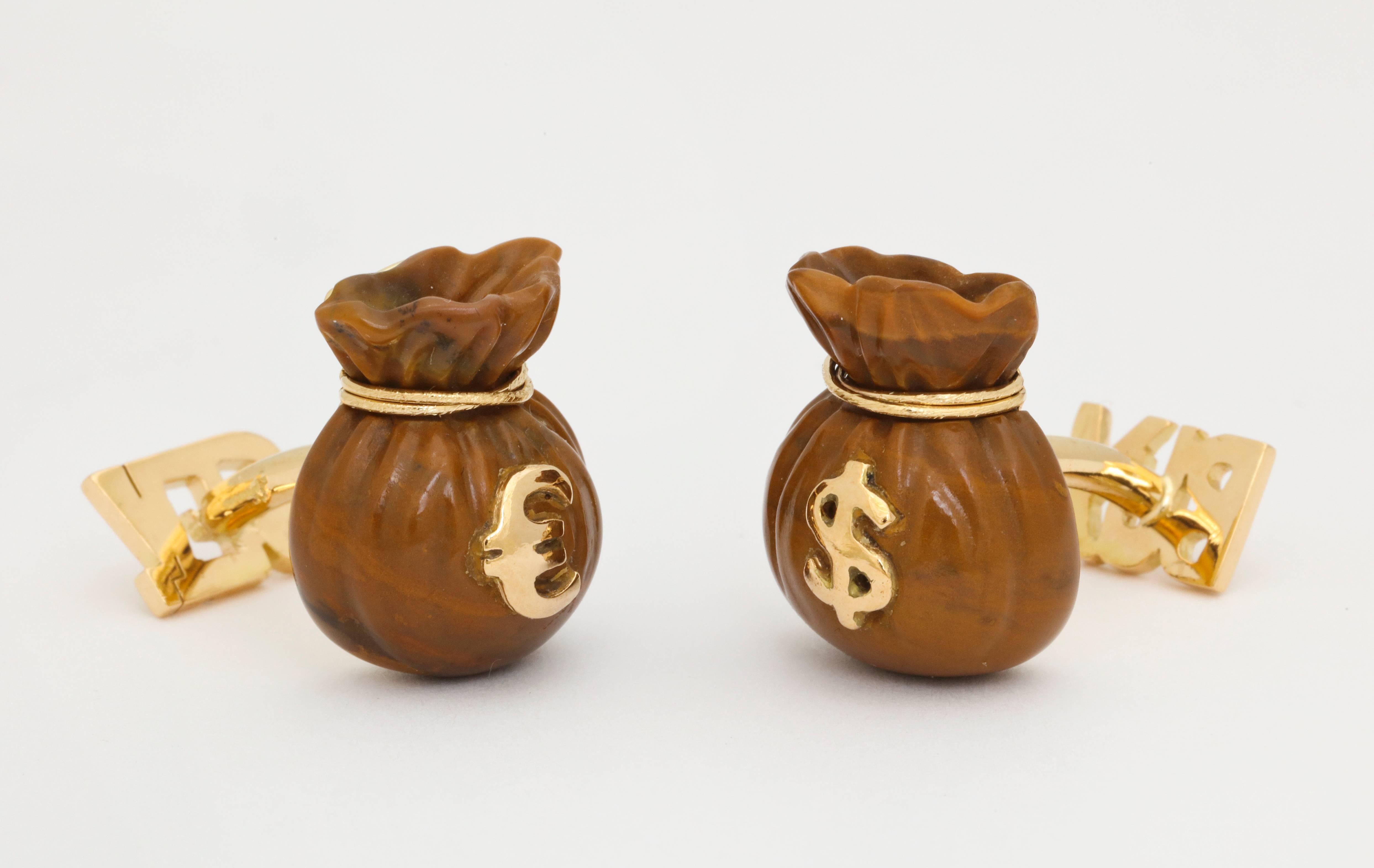 Whether a buyer or a seller, you can choose the dollar or the euro with these unique cufflinks.  Expertly carved in Germany from brown jasper, and finely mounted in Italy, they exhibit exceptional detail.

Cufflinks designed by Michael Kanners are