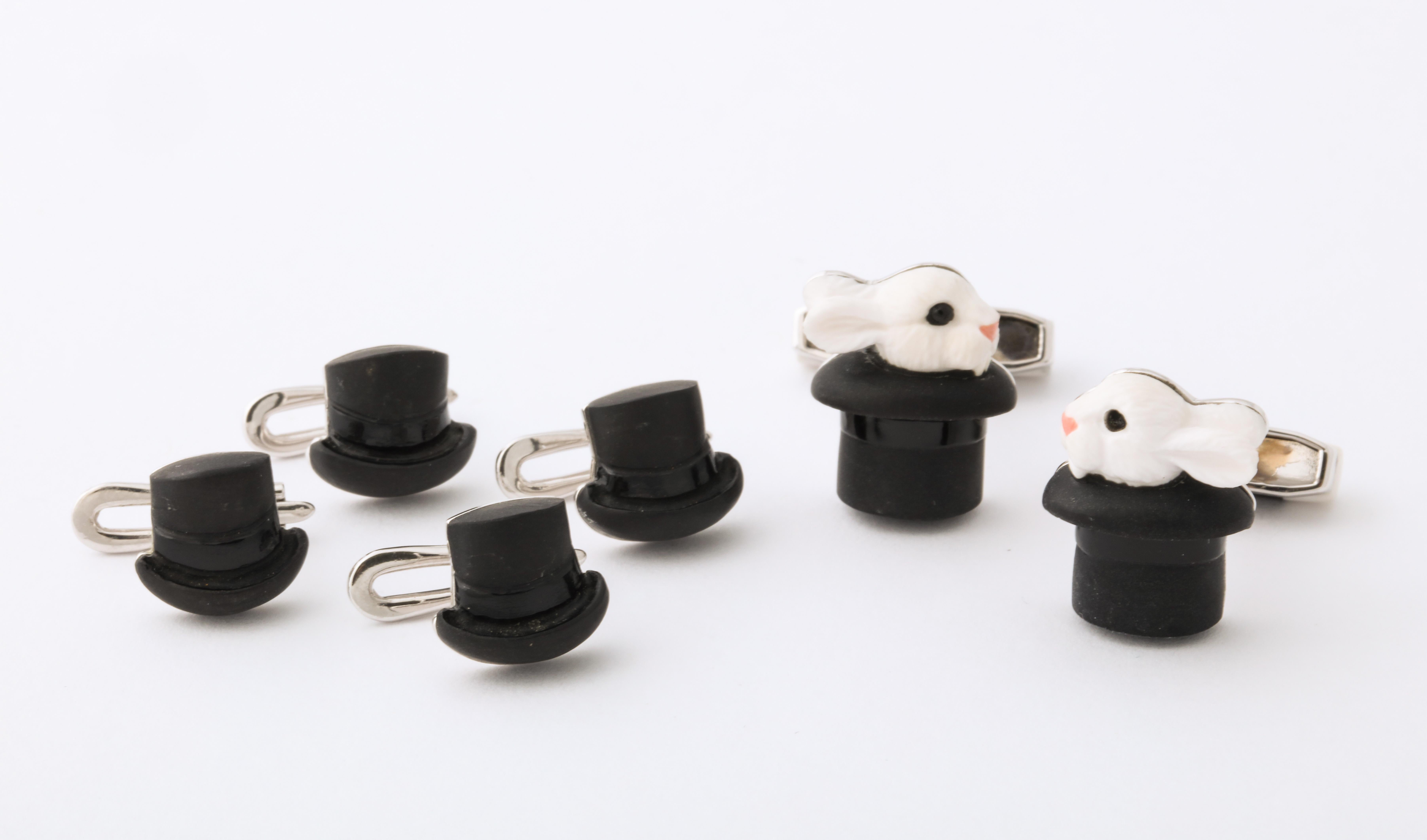 Intricately carved from cocholong and black onyx with enamel accents, these cufflinks and shirt studs are truly magical.  Using the the ancient art of intarsia, the two stones appear as one.  The spring back of the cufflinks even features a matching
