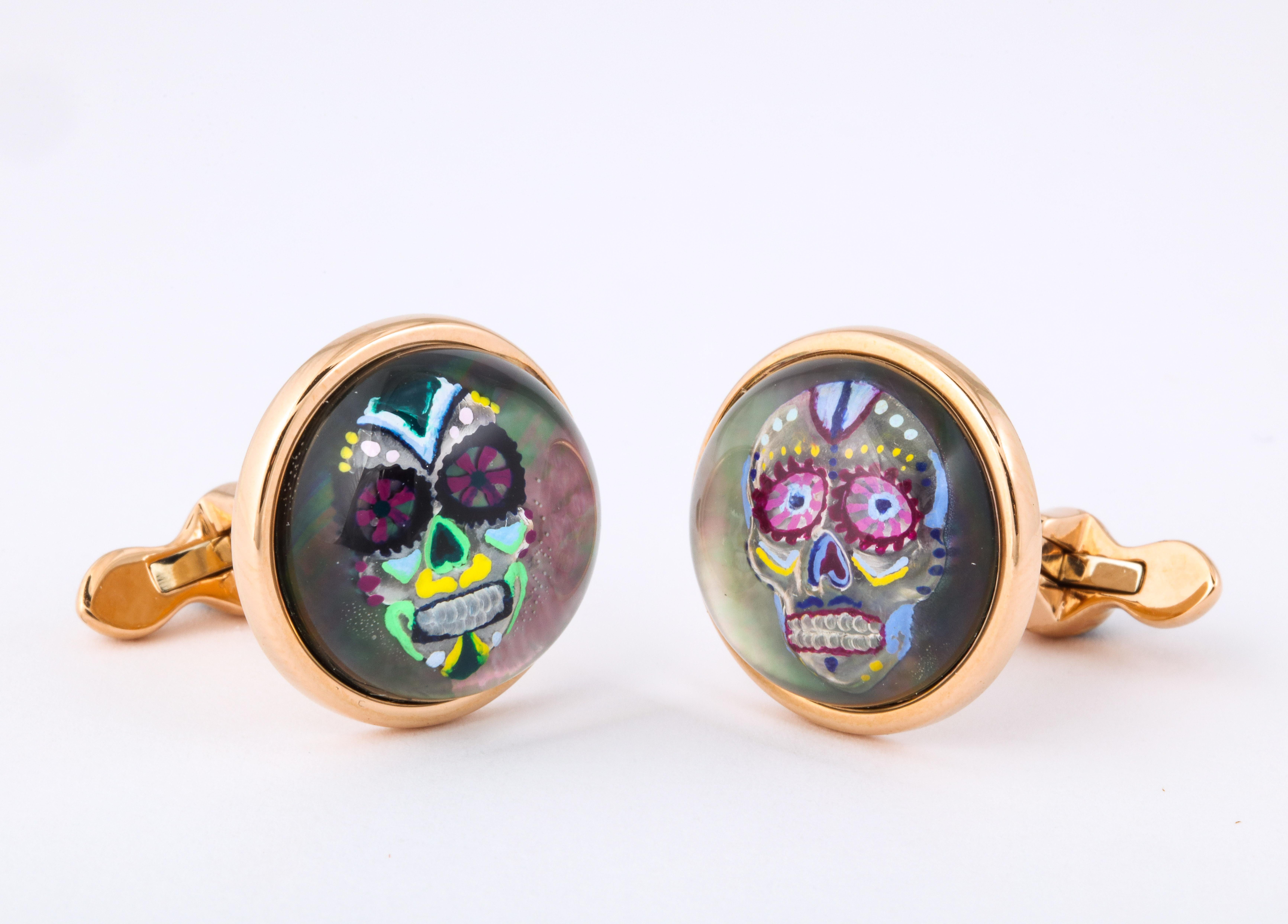 The exceptional detail and artistry in these one of a kind cufflinks is achieved through the use of reverse enameled rock crystal.  This technique begins by carving the design into the underside of a rock crystal quartz cabochon.  The artist then