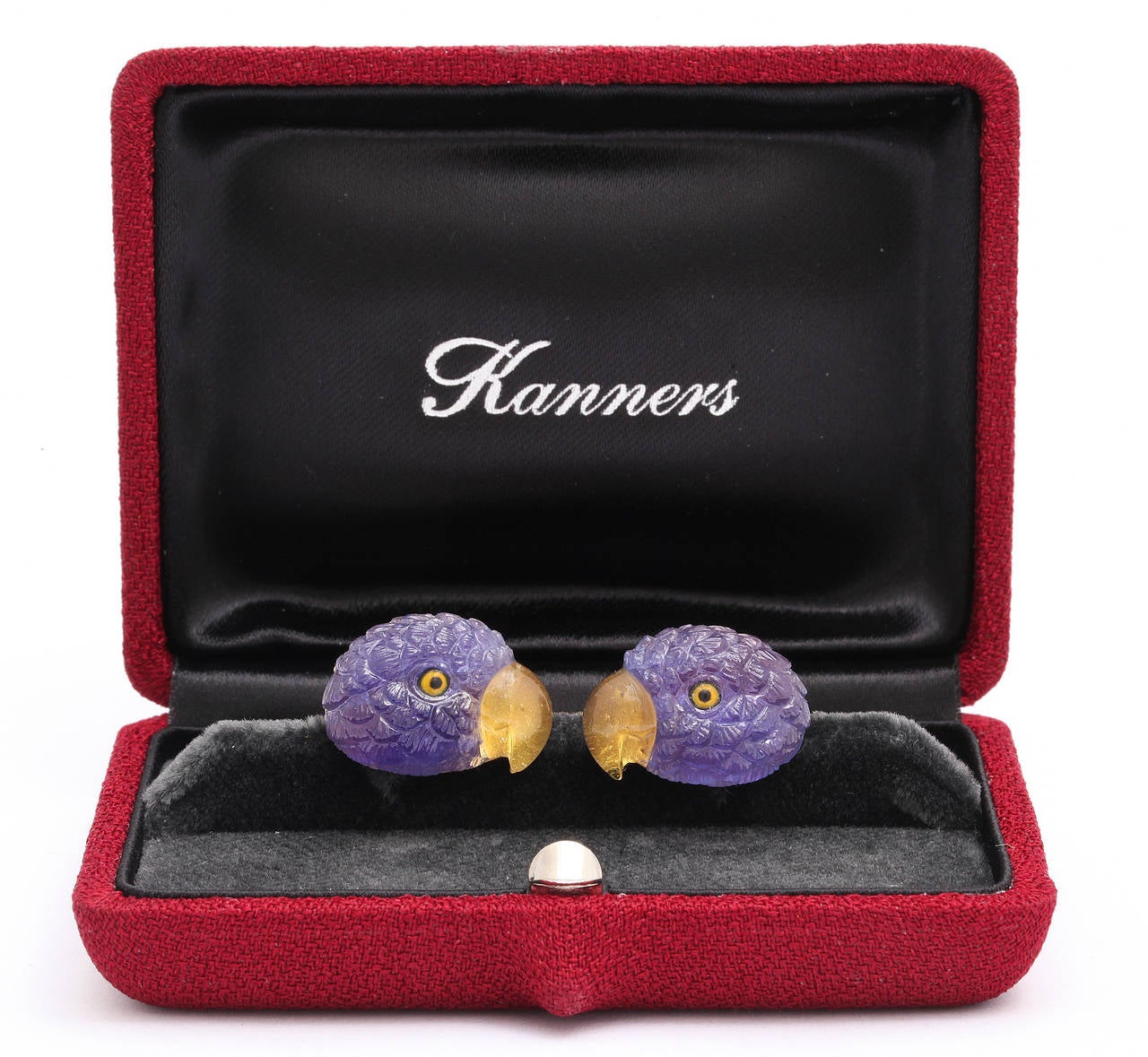 Very finely carved tanzanites in the form of parrot heads with yellow tourmaline beaks and rock crystal and enamel eyes.  The reverse spring back set with lapis-lazuli.  Nothing has been spared in the fine attention to detail and the superior