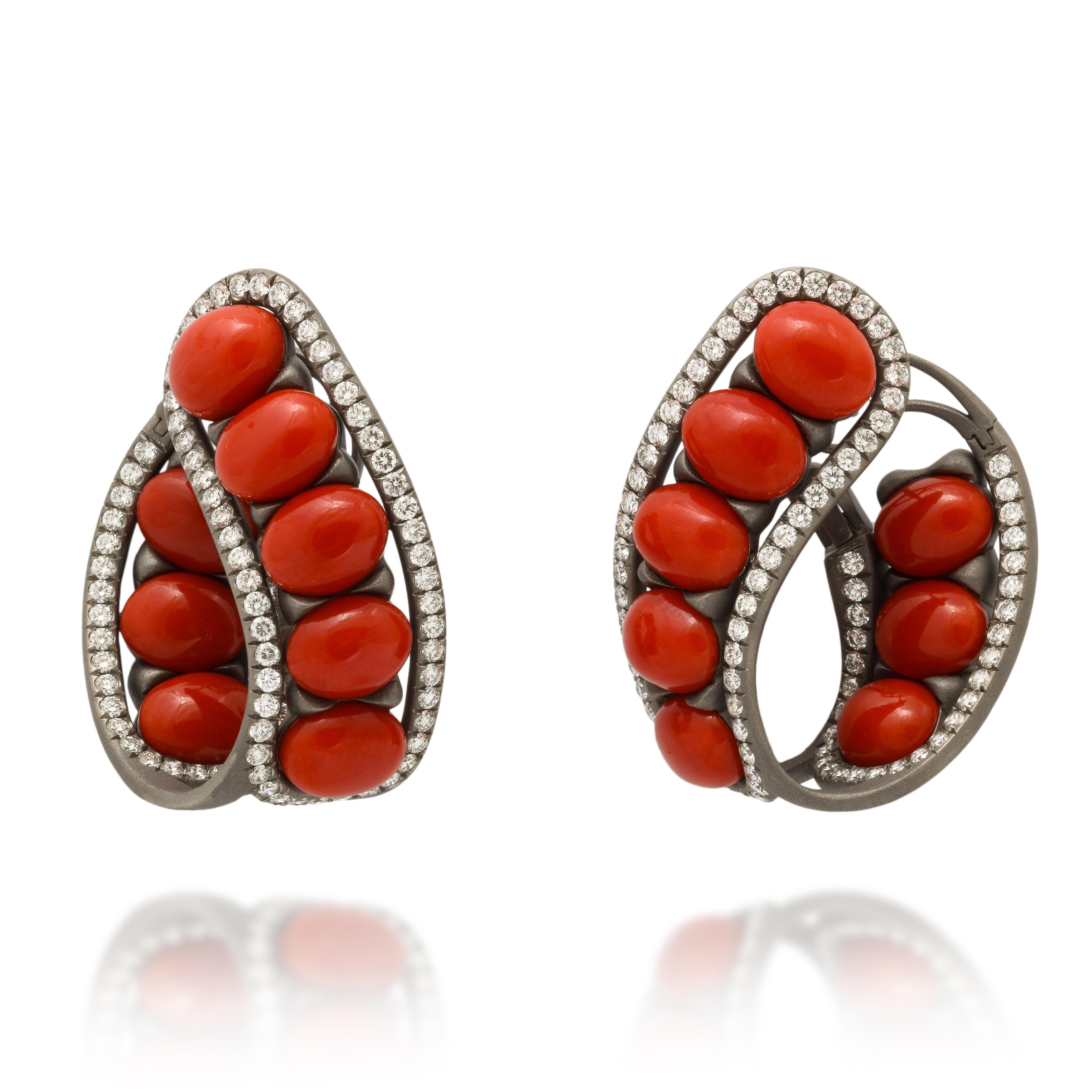 A bold and striking design, featuring bright red Mediterranean coral, framed with diamonds and mounted in brushed grey titanium.   At a full 1 1/2 x 1 1/4 inches these are definitely statement earrings, however the use of titanium makes them just