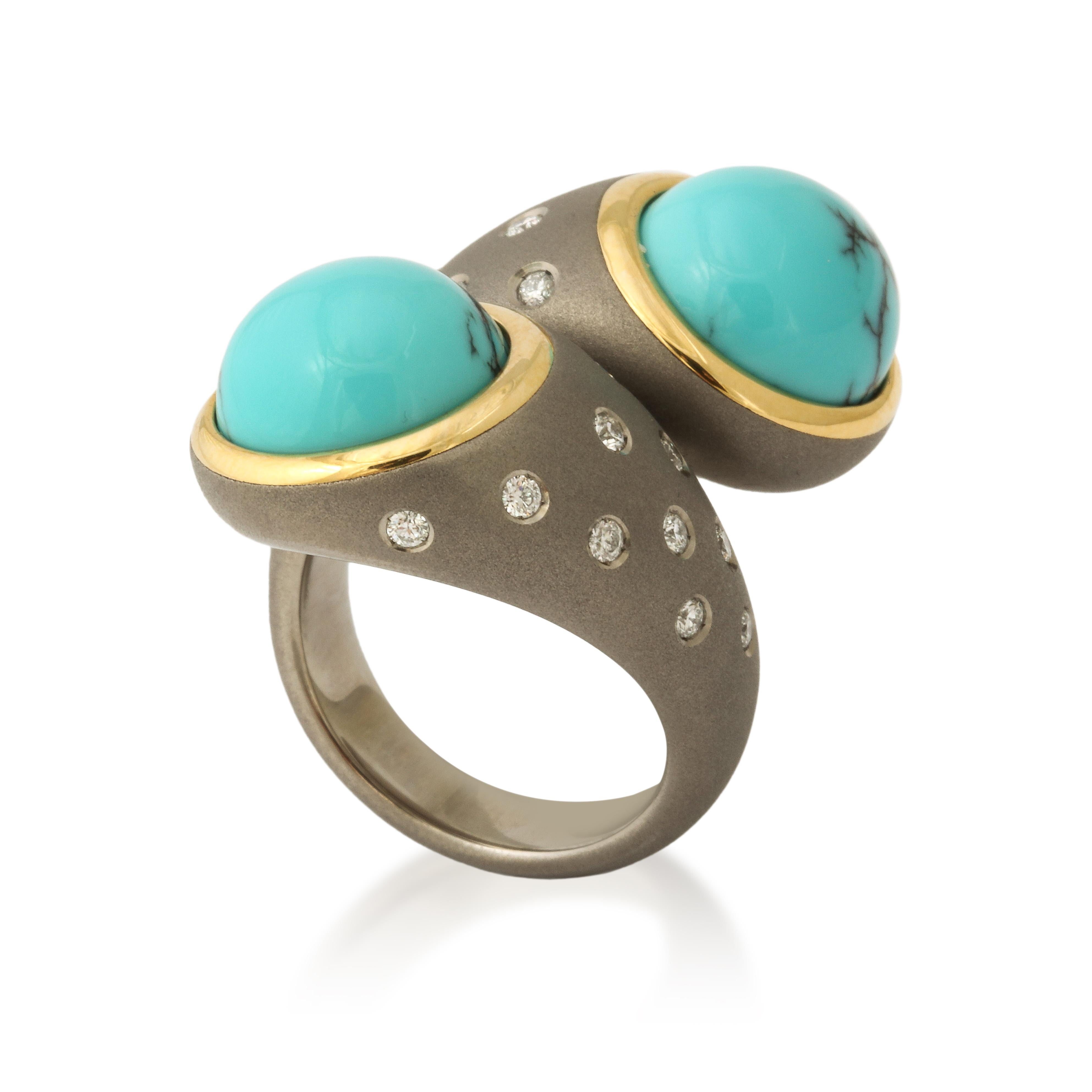 This ring embodies the perfect combination of nature and contemporary design with the beautiful pair of turquoise cabochons, revealing just a trace of their original black matrix, mounted in titanium.  For extra flair the mounting is set with