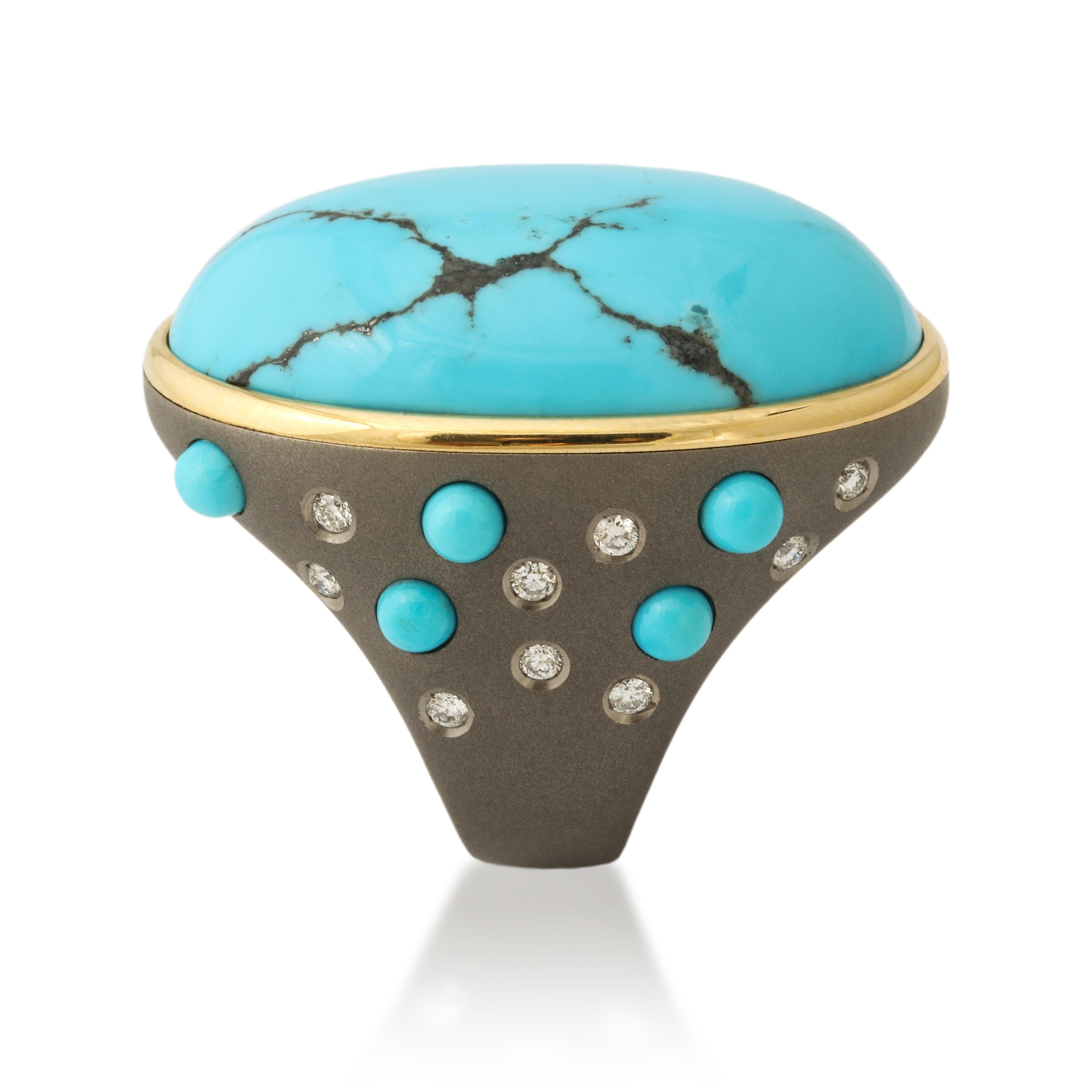 This ring embodies the perfect combination of nature and contemporary design with the impressive 44 carat turquoise, revealing a trace of it's original black matrix, mounted in titanium.  For extra flair the mounting is set with smaller turquoise