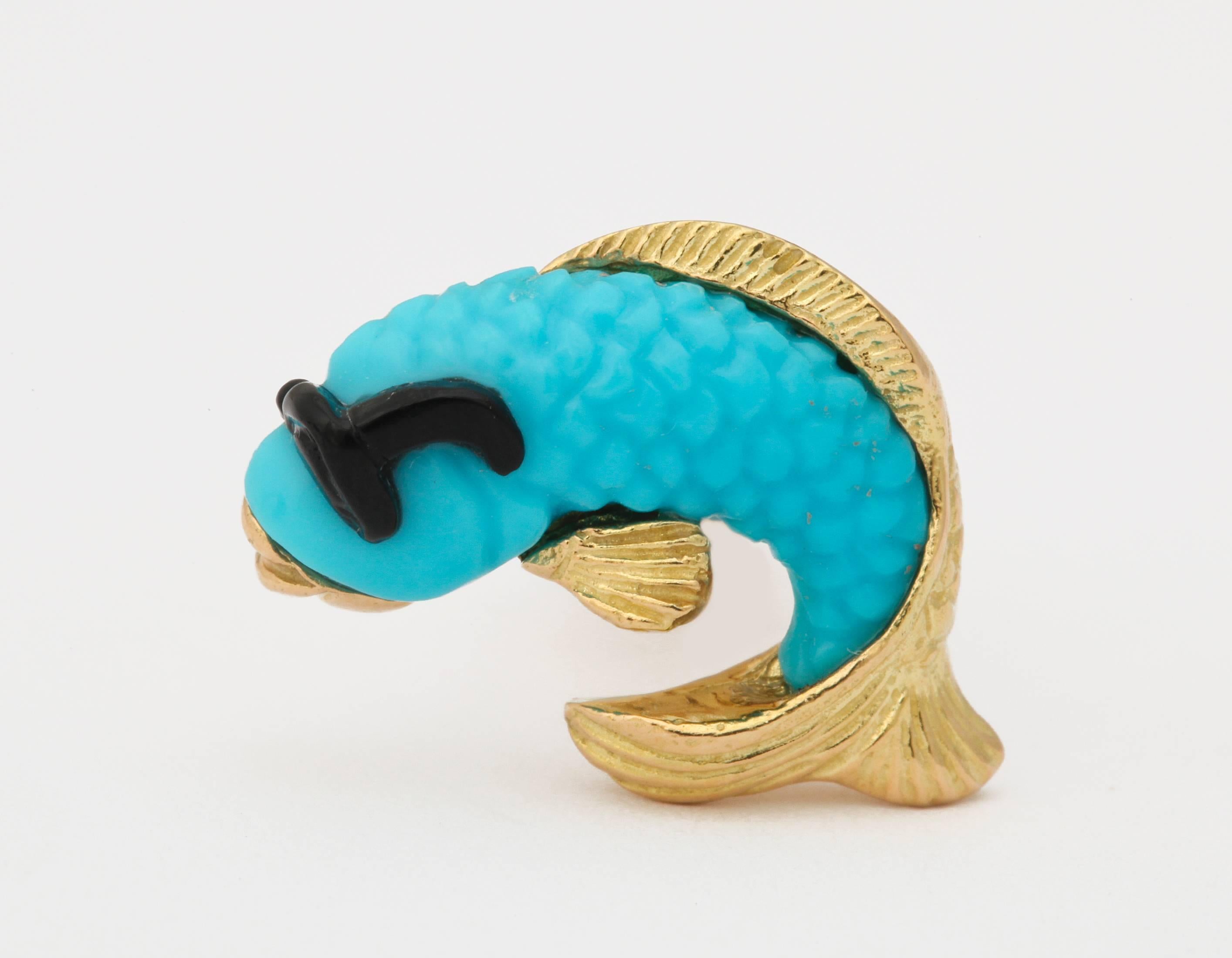 Look once at these cufflinks and you'll see the vibrant, blue turquoise.  Look twice and you'll see that the fish is wearing black onyx sunglasses.  Elegance with just the right amount of humor.  All mounted in 18kt gold and made in