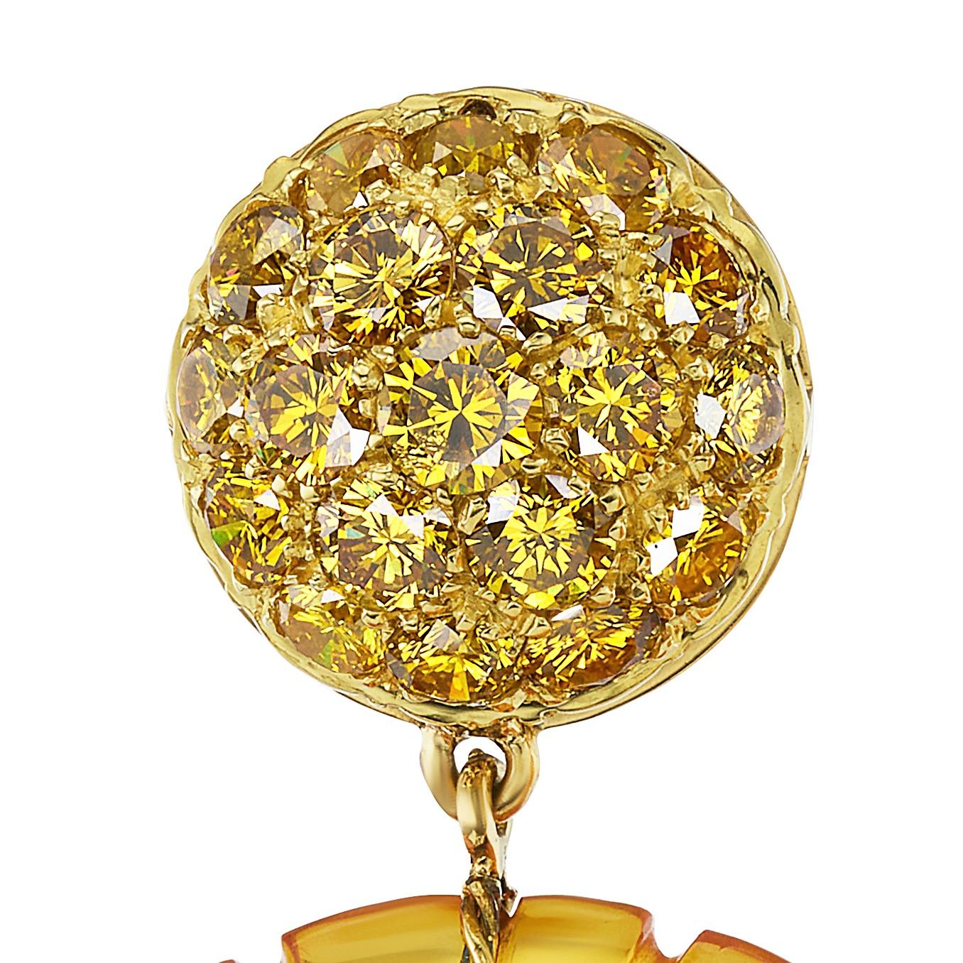 Radiating warmth and light, these one-of-a-kind earrings pair the golden fire of vibrant yellow diamonds with the sunlit glow of fluted amber drops. Each earring is a small sculpture of natural beauty—bold, bright, and feather-light on the