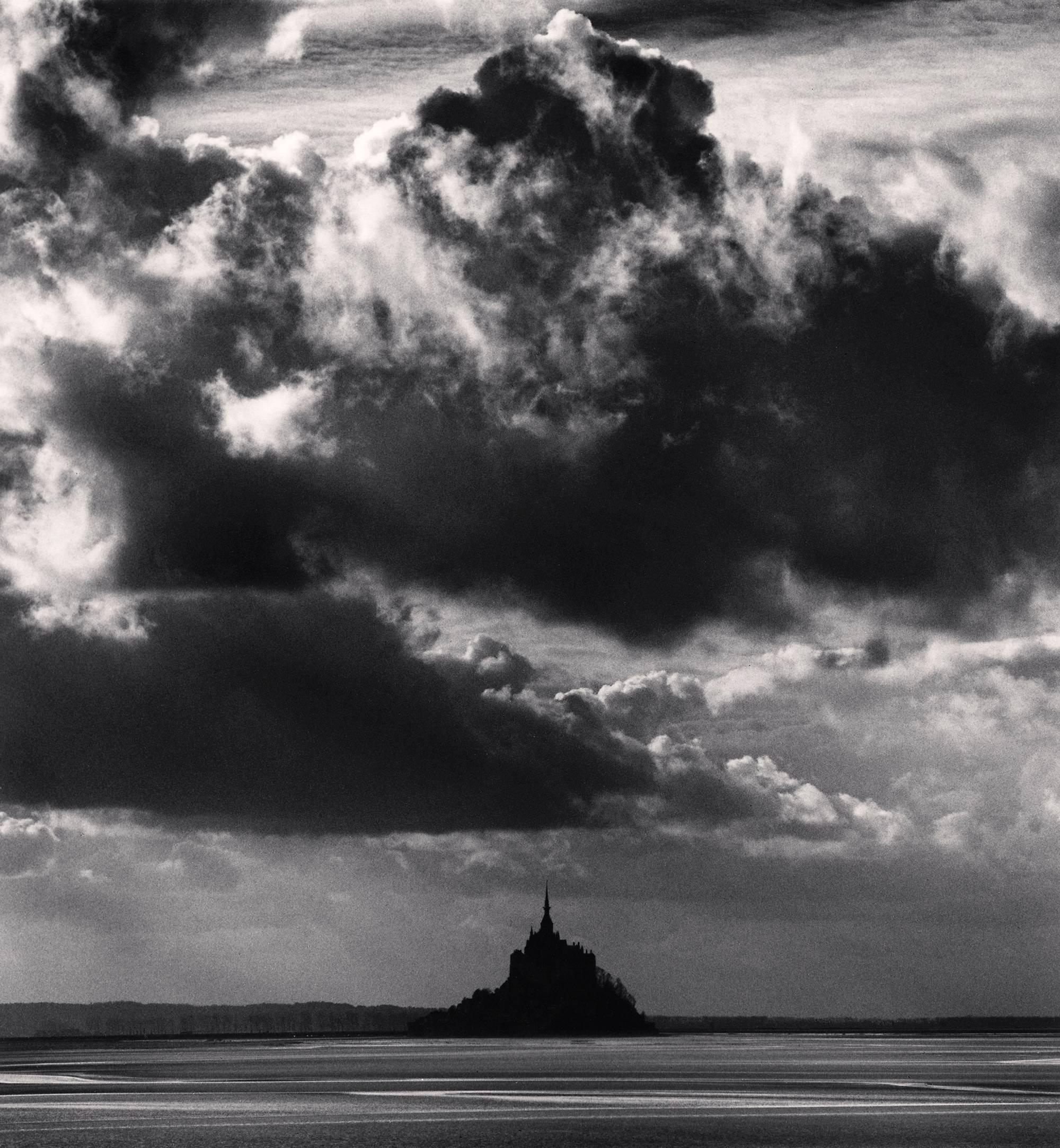 Michael Kenna Black and White Photograph - November Clouds, Mont St. Michel, France. 2000, LTD silver gelatin print