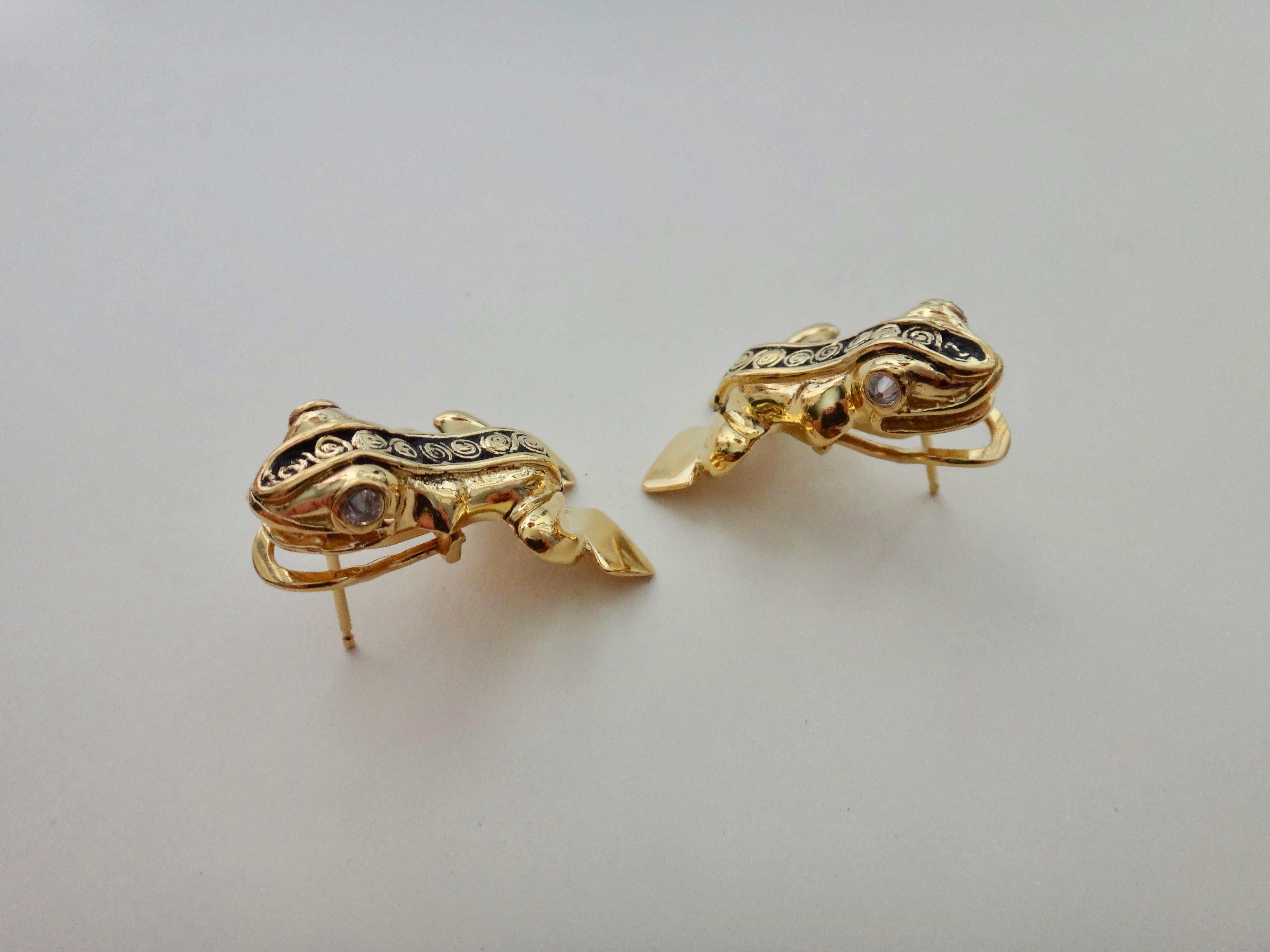The Inca Frog Earrings are a playful pair of 18k yellow gold frogs inspired by Inca imagery.  Throughout history including the Incan culture, the much love frog is a symbol of fertility and renewal.  These frogs come alive with reverse set diamond