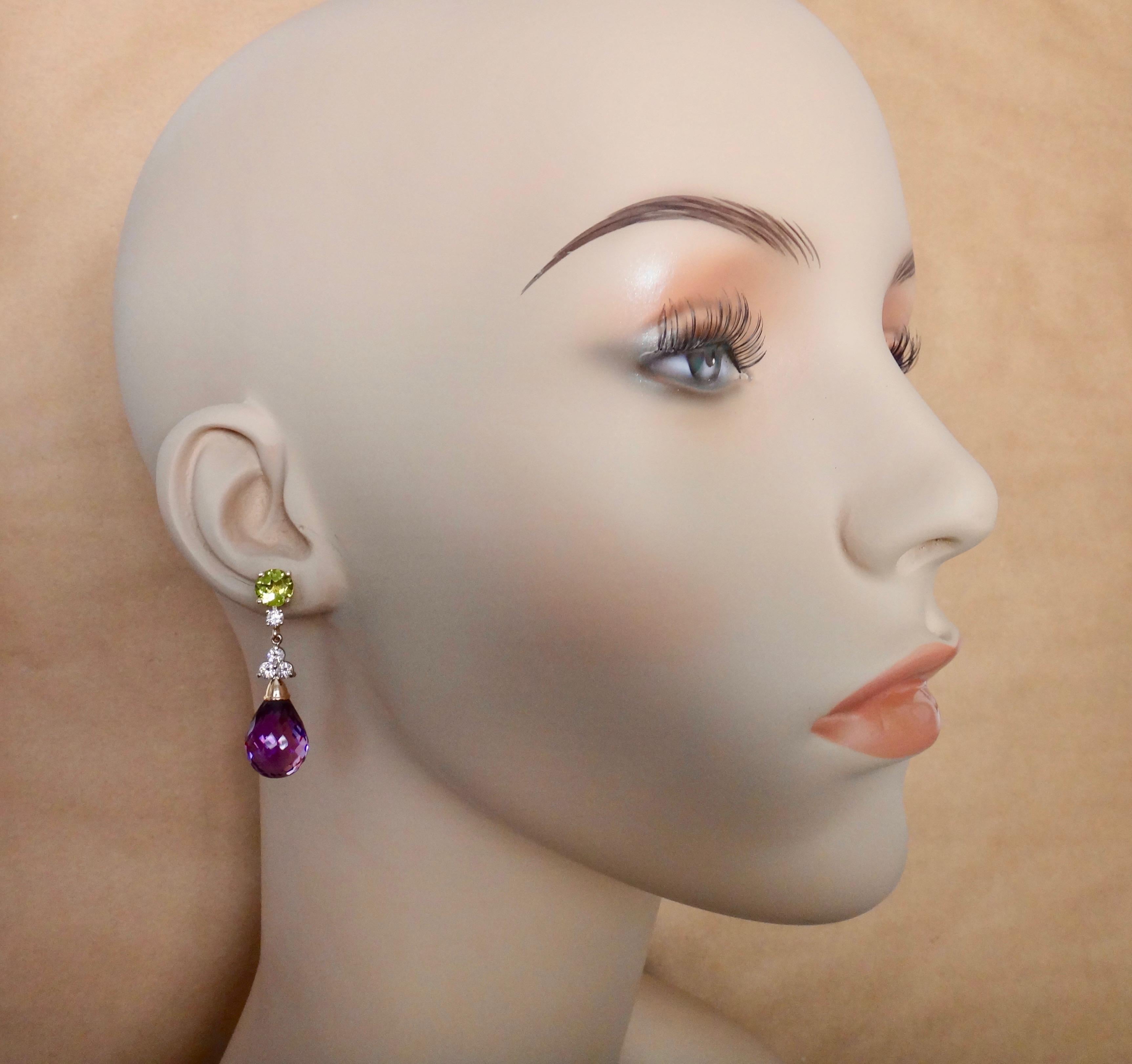 Royal purple amethyst briolettes (origin: Brazil) are complimented by round cut peridots (origin: Pakistan) in these bold dangle earrings.  Purple and green is a dynamic color combination, well displayed here.  The gems are further enhanced  by