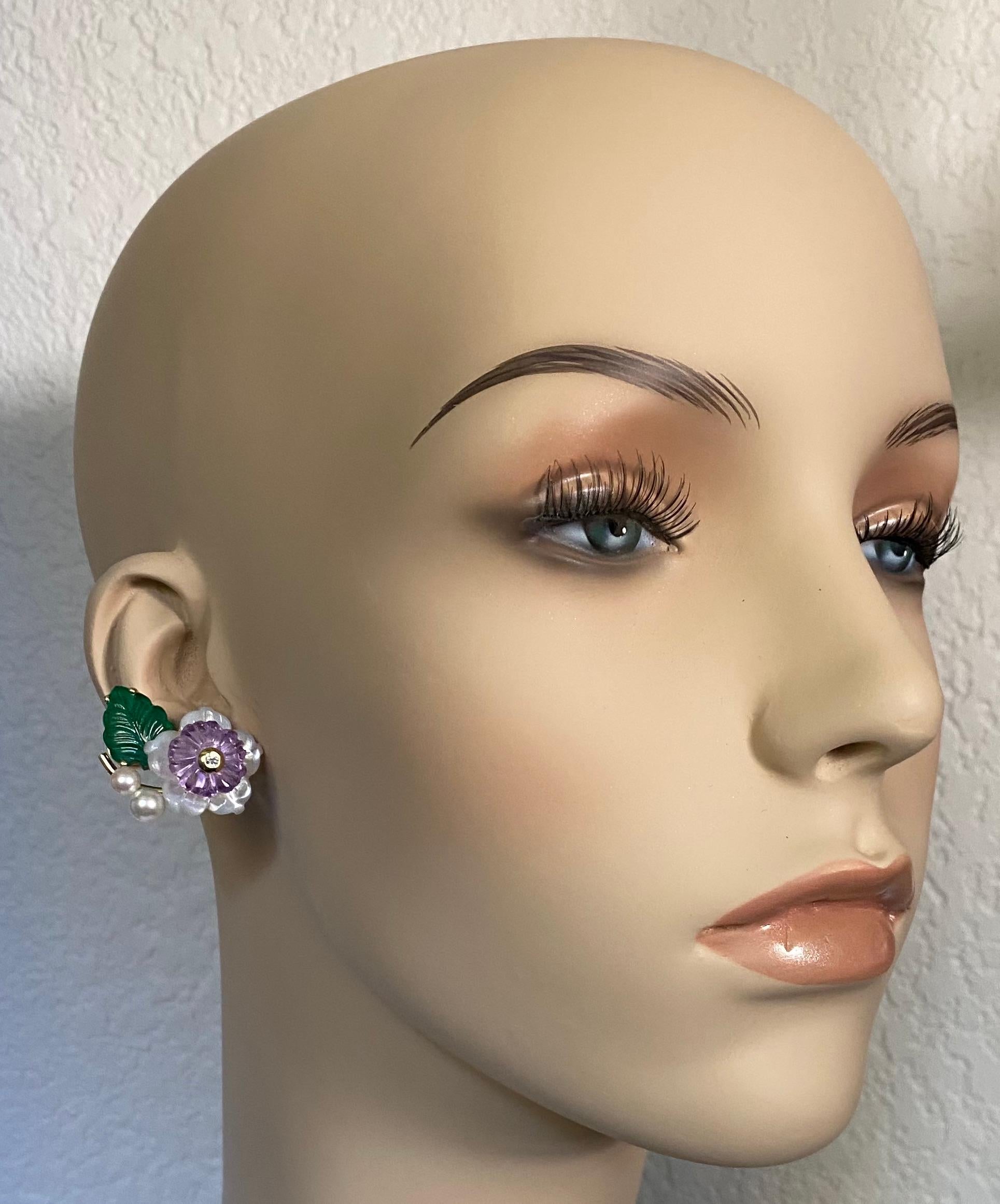 A composition of carved gems combine to form these elegant and timeless flower earrings.  Expertly executed carvings of  amethyst, mother-of-pearl and green onyx, are complimented by Akoya pearls and white diamonds.  The hand fabricated 18k yellow