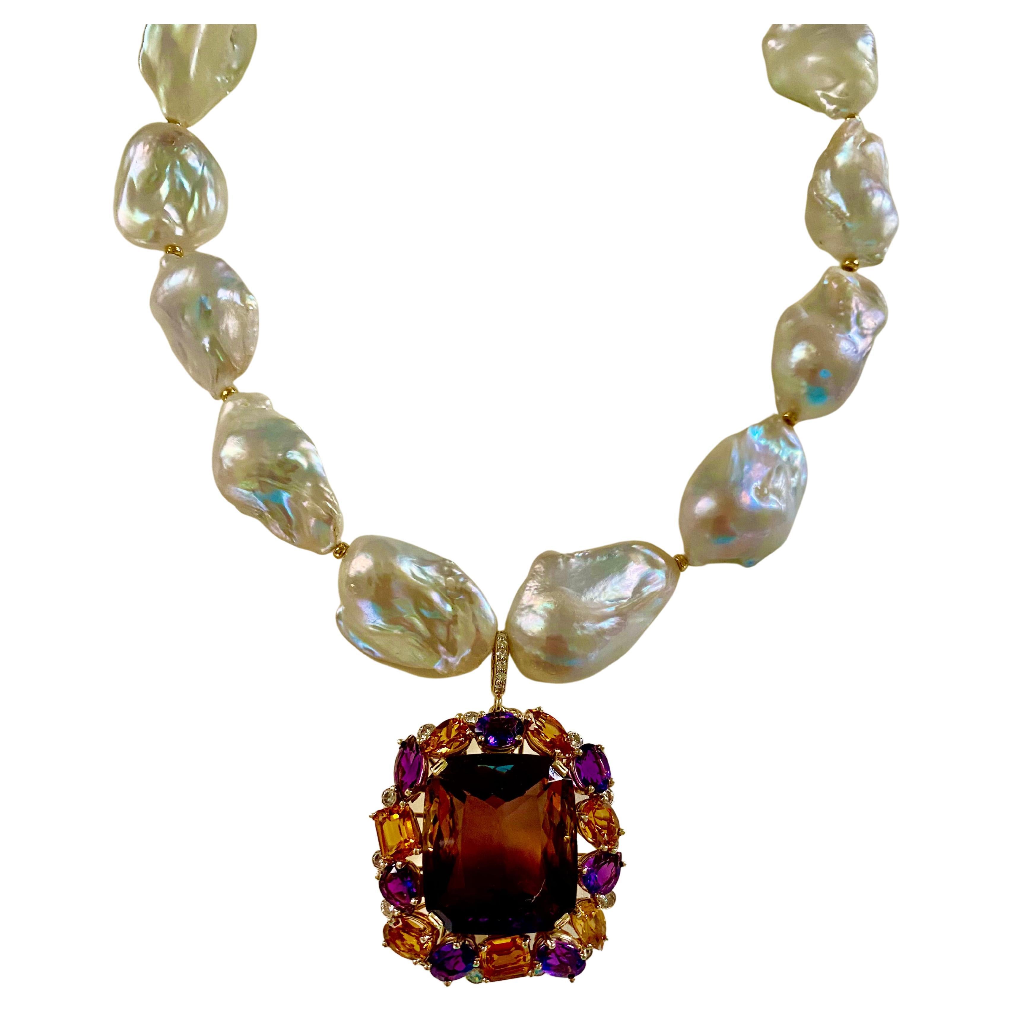 A gem quality ametrine forms the nucleus of this extravagant, one-of-a-kind necklace.  The ametrine (origin: Bolivia) weighs 72.76 carats and is richly colored in both purple and yellow.  The gem is well cut and polished in a modified cushion cut.