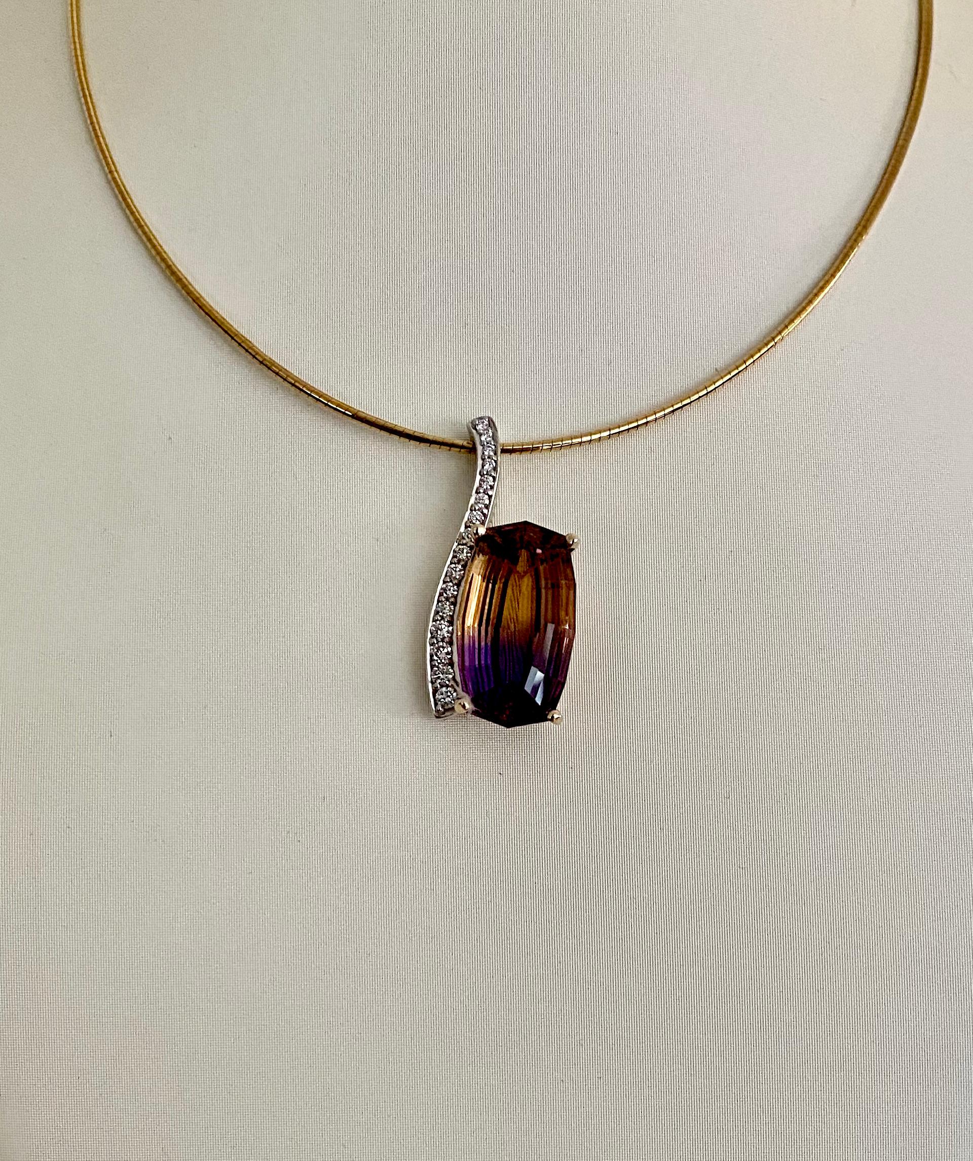 An ametrine of 21.84 carats is set with diamonds in this Wave pendant.  Ametrine (origin: Bolivia) is a spontaneous pairing of two members of the quartz family, amethyst and citrine.  This boldly colored gem is expertly cut and polished in a