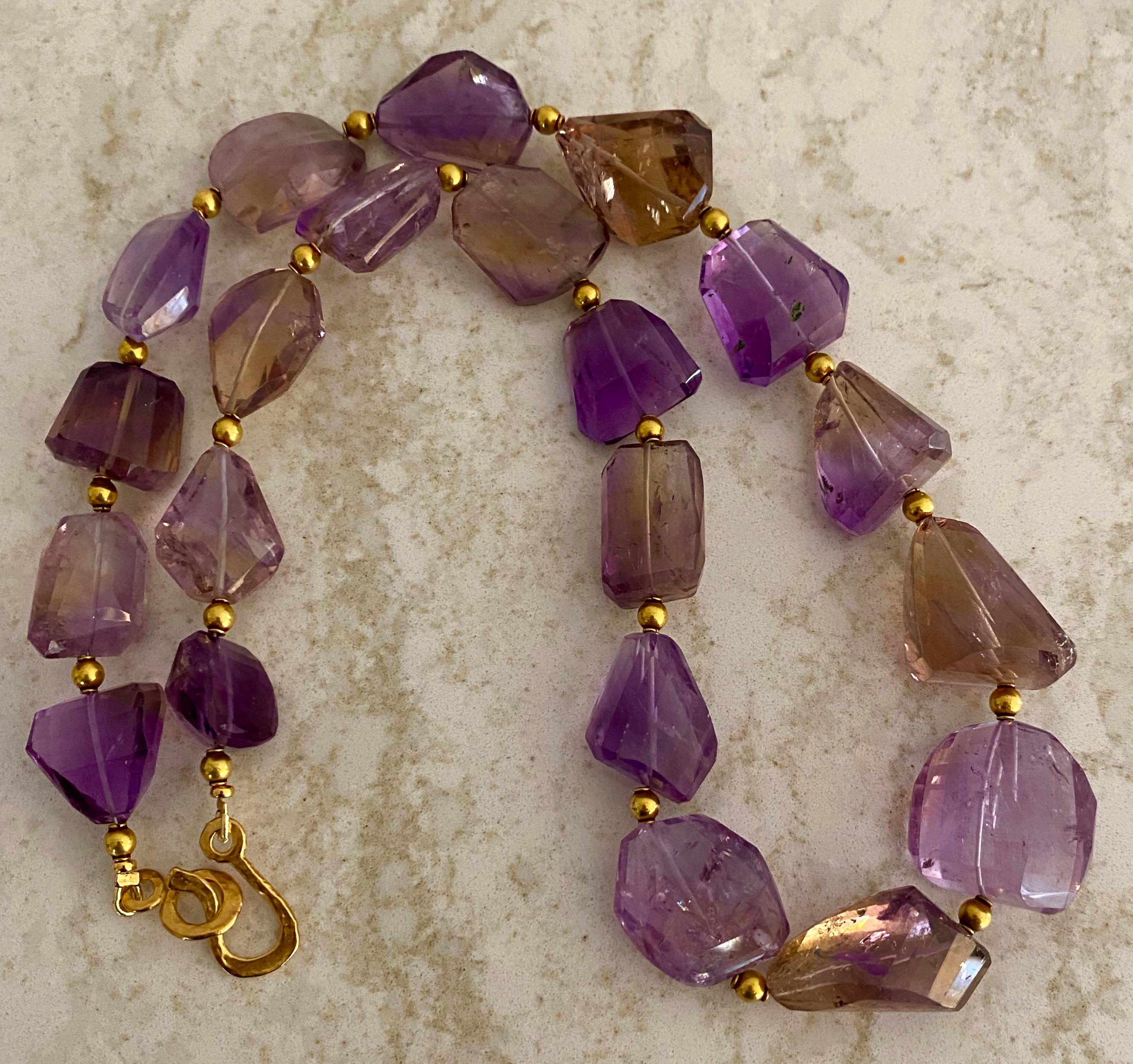 Ametrine beads in luscious lavender and gold shades are presented in this impressive necklace.  Ametrine (origin: Bolivia) is a naturally occurring variety of quartz.  Each gem is a mixture of amethyst and citrine with zones of each color-thus the