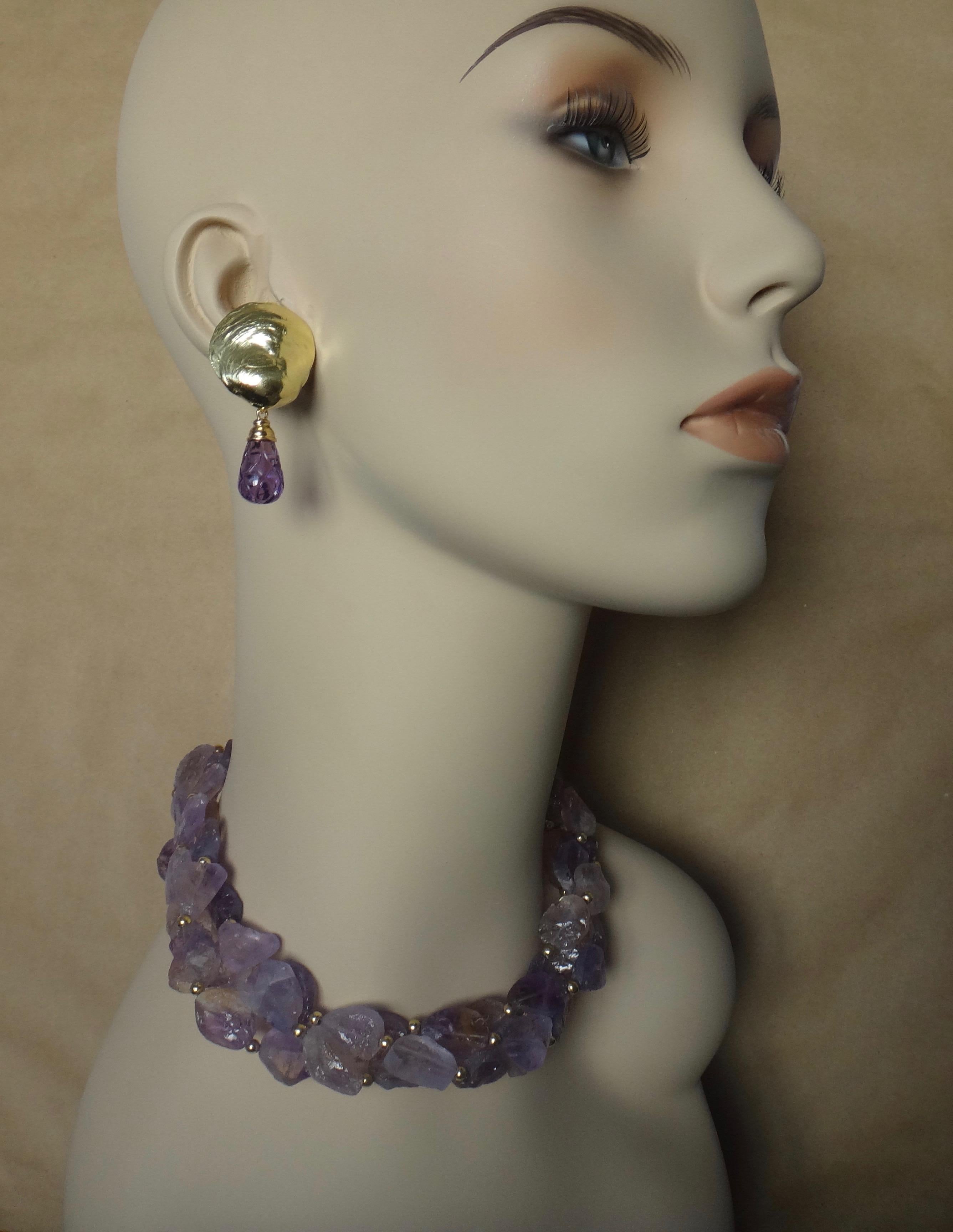 Paired is this ametrine torsade necklace and amethyst jingle earrings forming a most striking suite.  Ametrine (origin: Bolivia)  refers to the fact that both amethyst and citrine are found within the same stone.  These beads were created in a