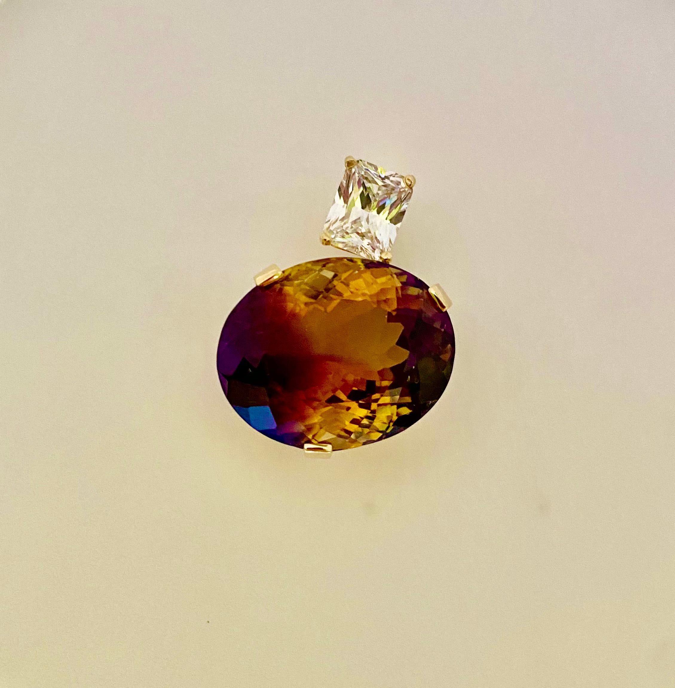 Ametrine is paired with white sapphire in this one-of-a-kind Due Gemme pendant.  Ametrine (origin: Bolivia) is an unusual bi-color form of quartz, half amethyst and half citrine, thus the name ametrine.  This gem is a wapping 54.55 carats.  More