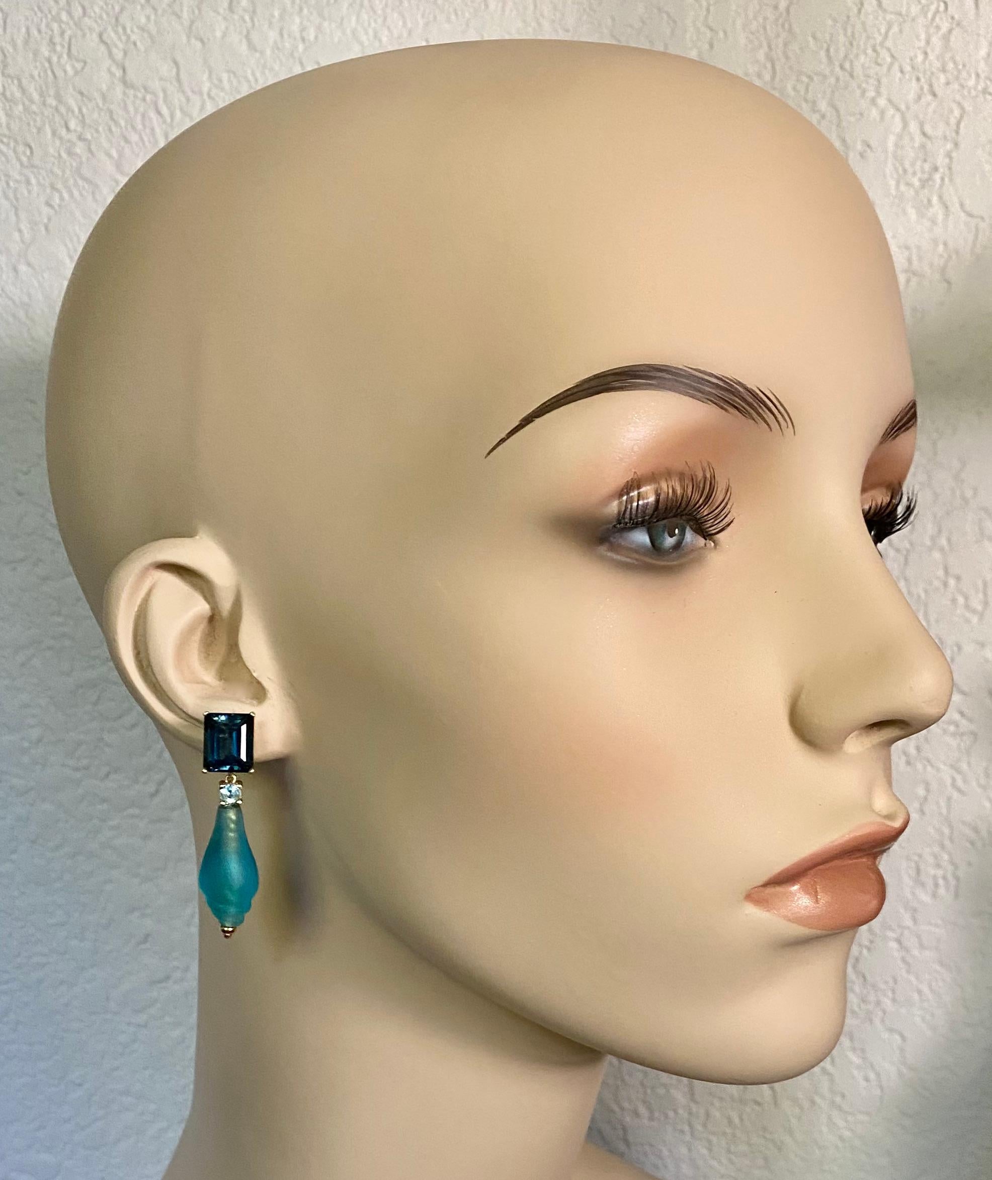 Ancient glass beads are complimented with blue topaz in these dangle earrings.  The beads, dating to the 11th century, were created by the Pyu people of northern Burma, now Myanmar.  The turquoise colored beads are shell shaped. Over centuries in