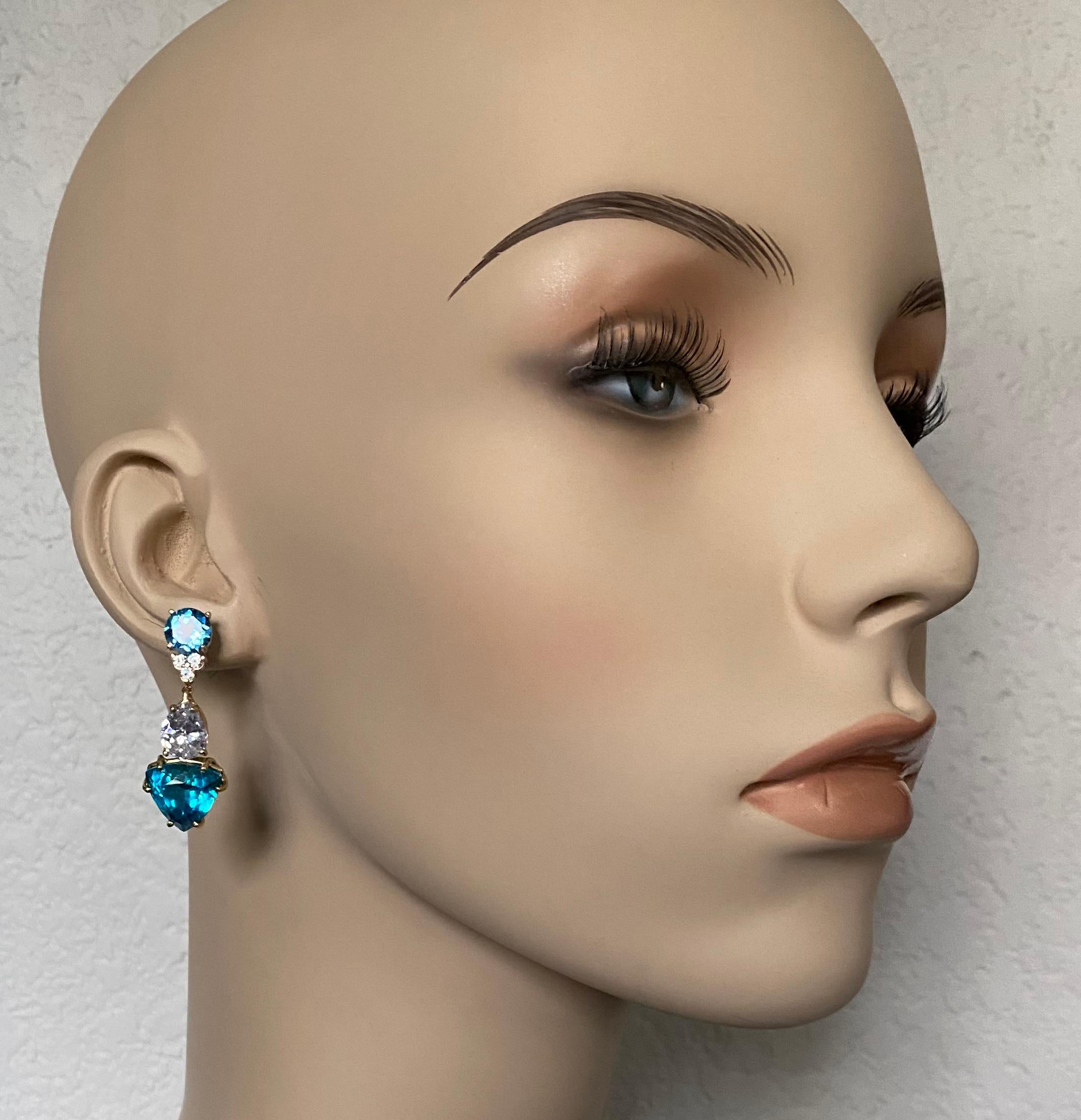A blending of blue shades define these sophisticated dangle earrings.  Trillion shaped apatite (origin: Myanmar) are electric in their colors and are well cut and faceted.  Complimenting the apatite are brilliant cut blue topaz and blue zircon