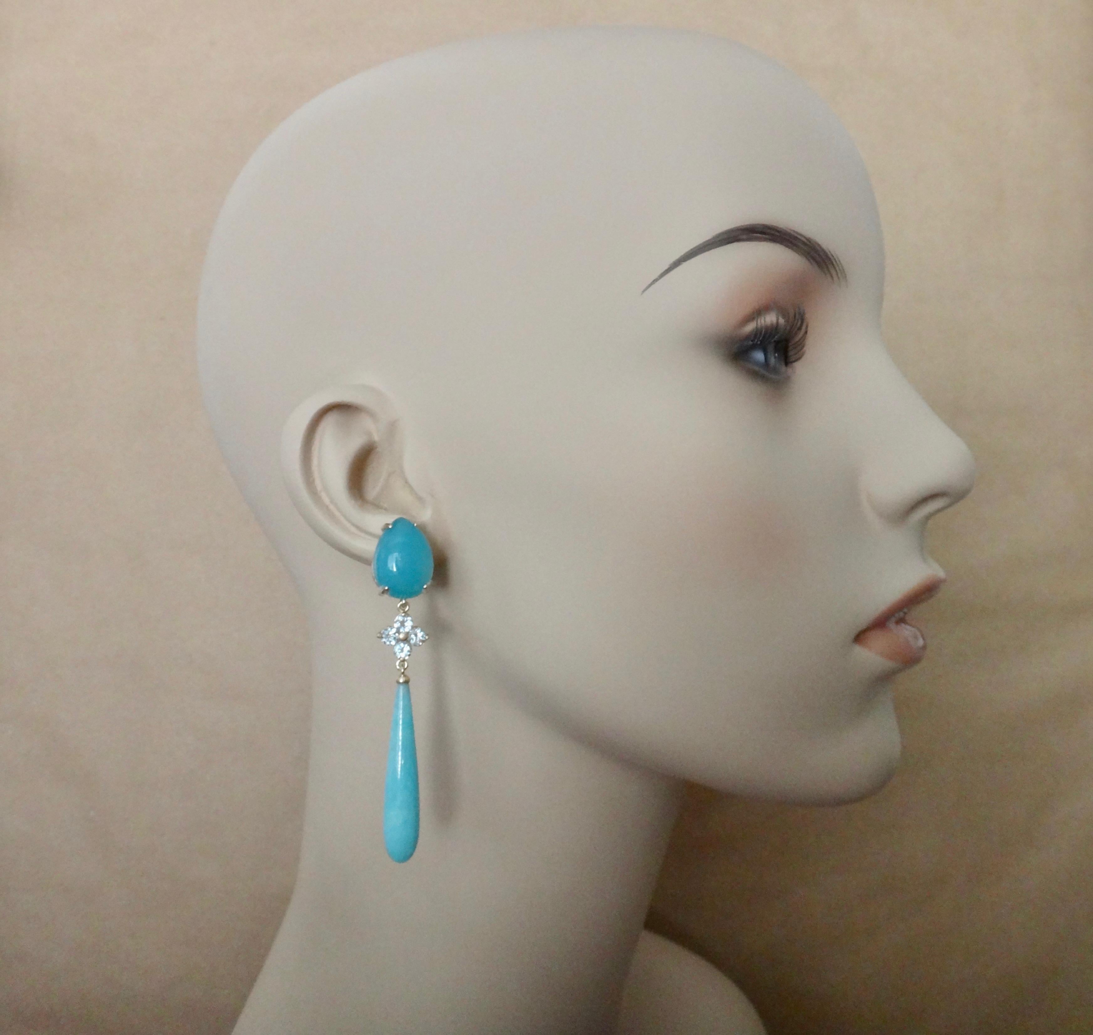 Aqua/blue chalcedony (origin: Uruguay) is complimented by eight brilliant cut aquamarines (origin: Brazil), and amazonite clubs (origin: Colorado, United States) in these outstanding dangle earrings.  The chalcedony is polished to a glass-like
