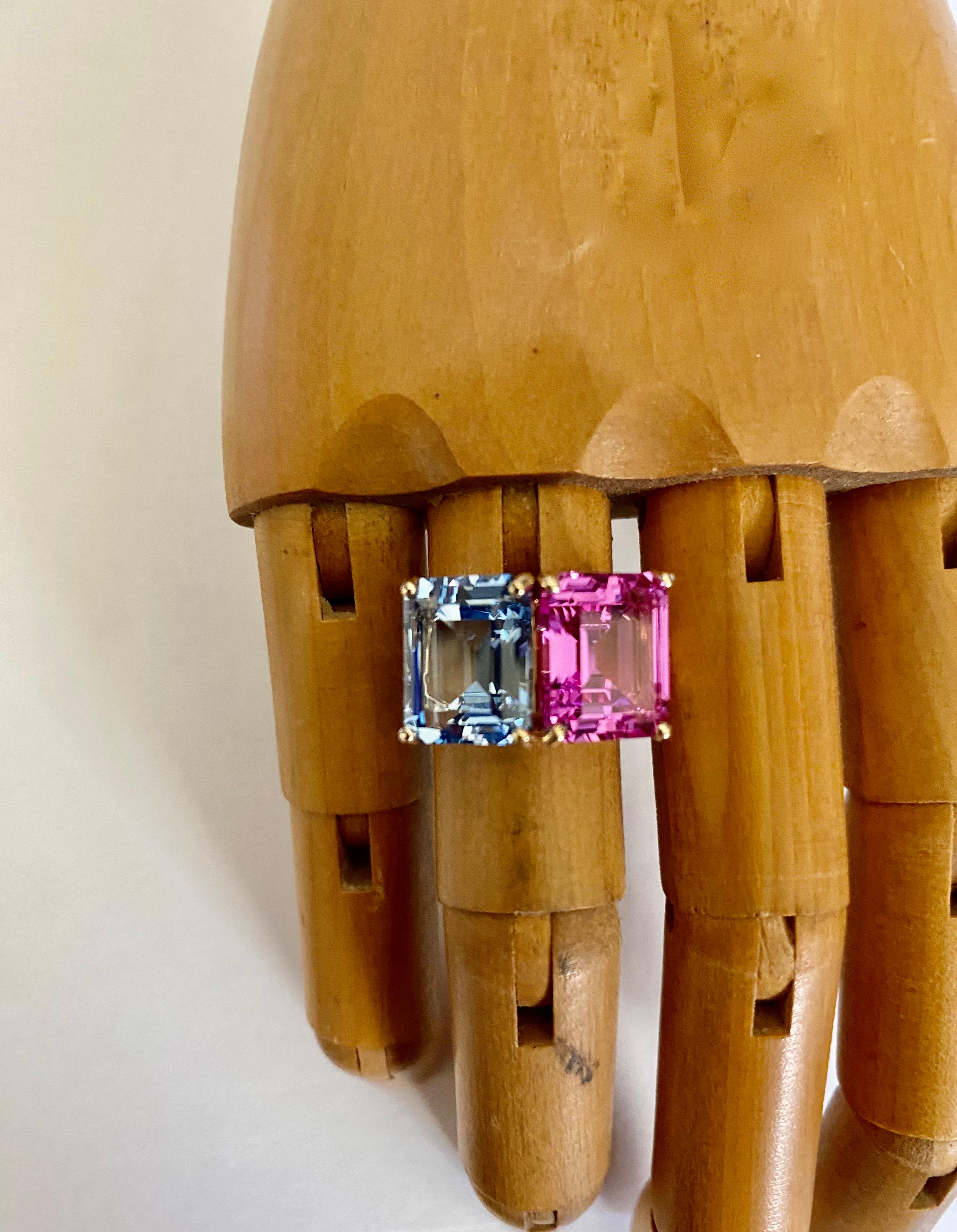 Aquamarine is paired with pink topaz in this Due Gemme ring.  The aquamarine is a classic aqua blue color and is well cut and polished.  The pink topaz is Bazooka Bubble Gum pink and is also expertly cut and polished.  The perfectly matched pair of