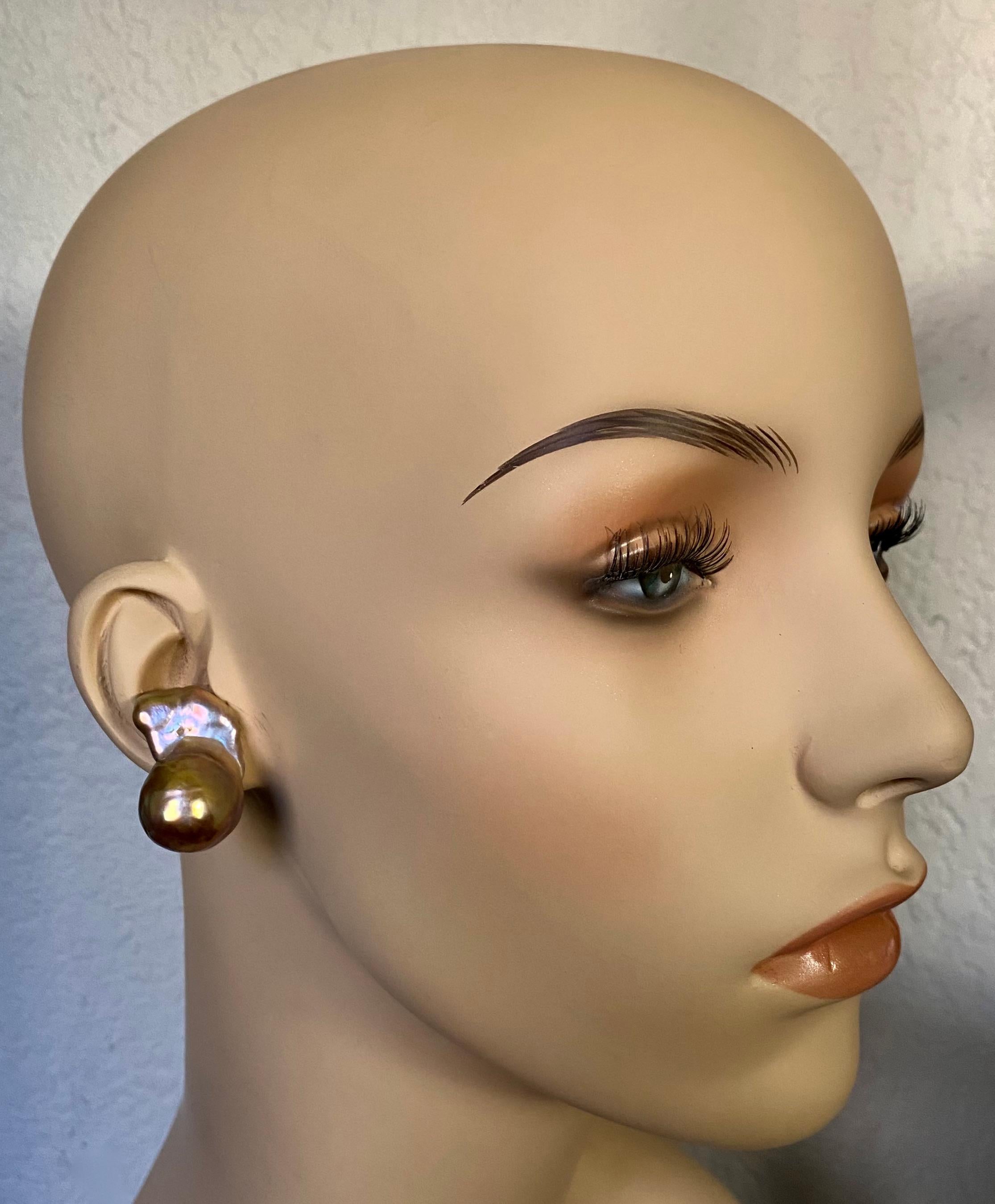Baroque pearls are showcased in these dramatic button earrings.  The pearls are among the largest on the market today.  The pearls have a pink foundation and possess a metallic luster that reflects a full range of colors.  The fluid shape of the