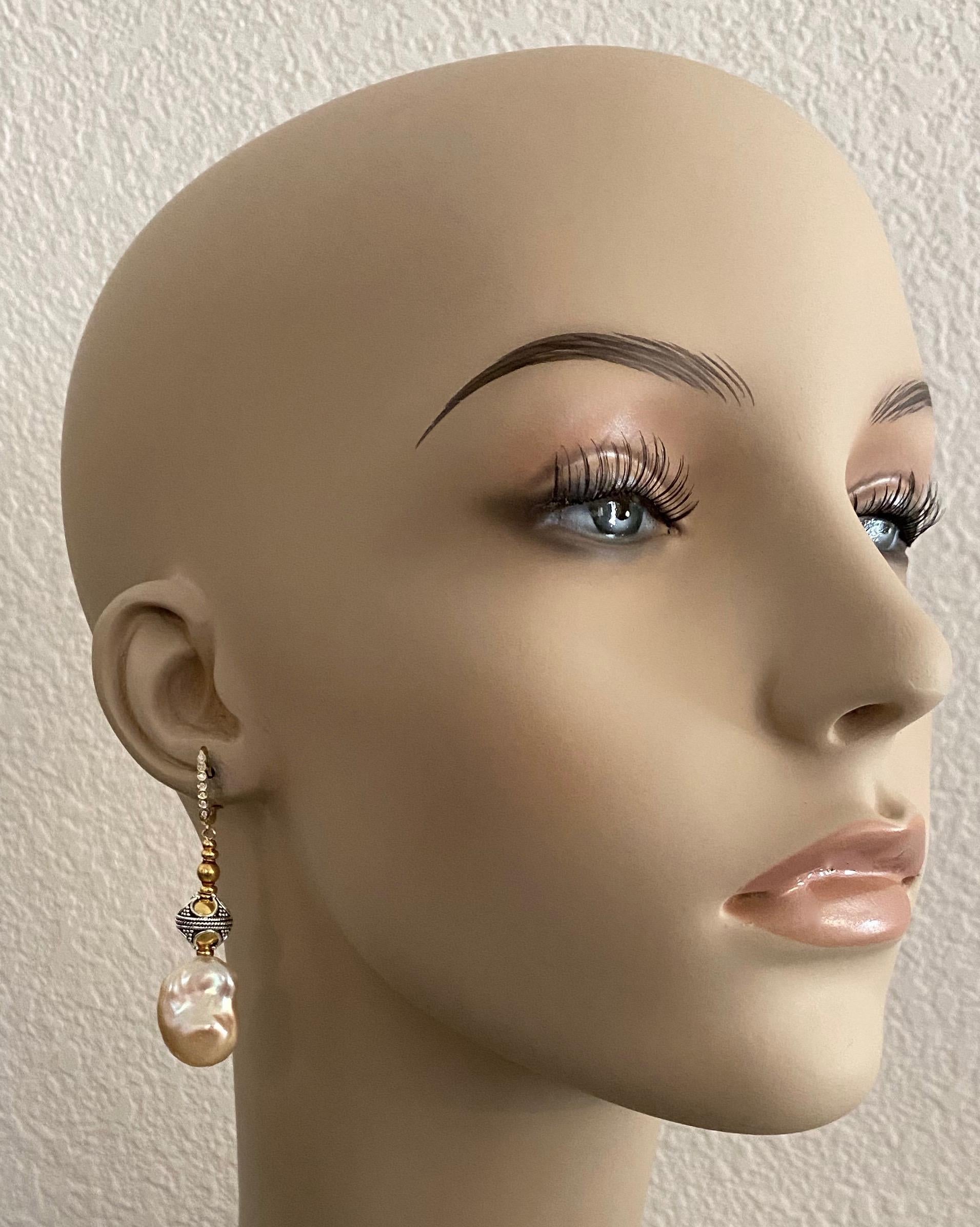 Peach colored baroque freshwater pearls (origin: China) are featured in these elegant dangle earrings.  The pearls measure 21mm x 13mm, are blemish free and possess wonderful luster.  The earrings are further decorated with 18k gold and silver and