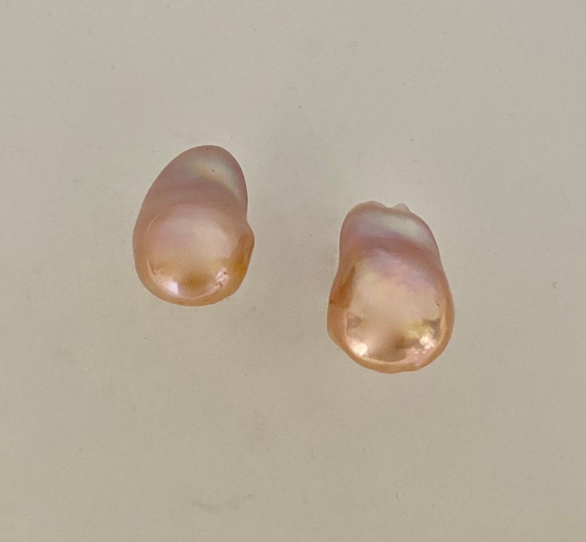 Baroque pearls are presented in these classic and elegant stud earrings.  The freshwater pearls (origin: China) are a luscious peachy/pink color.  They possess the rich luster freshwater pearls are renowned for having.  The baroque shape is called