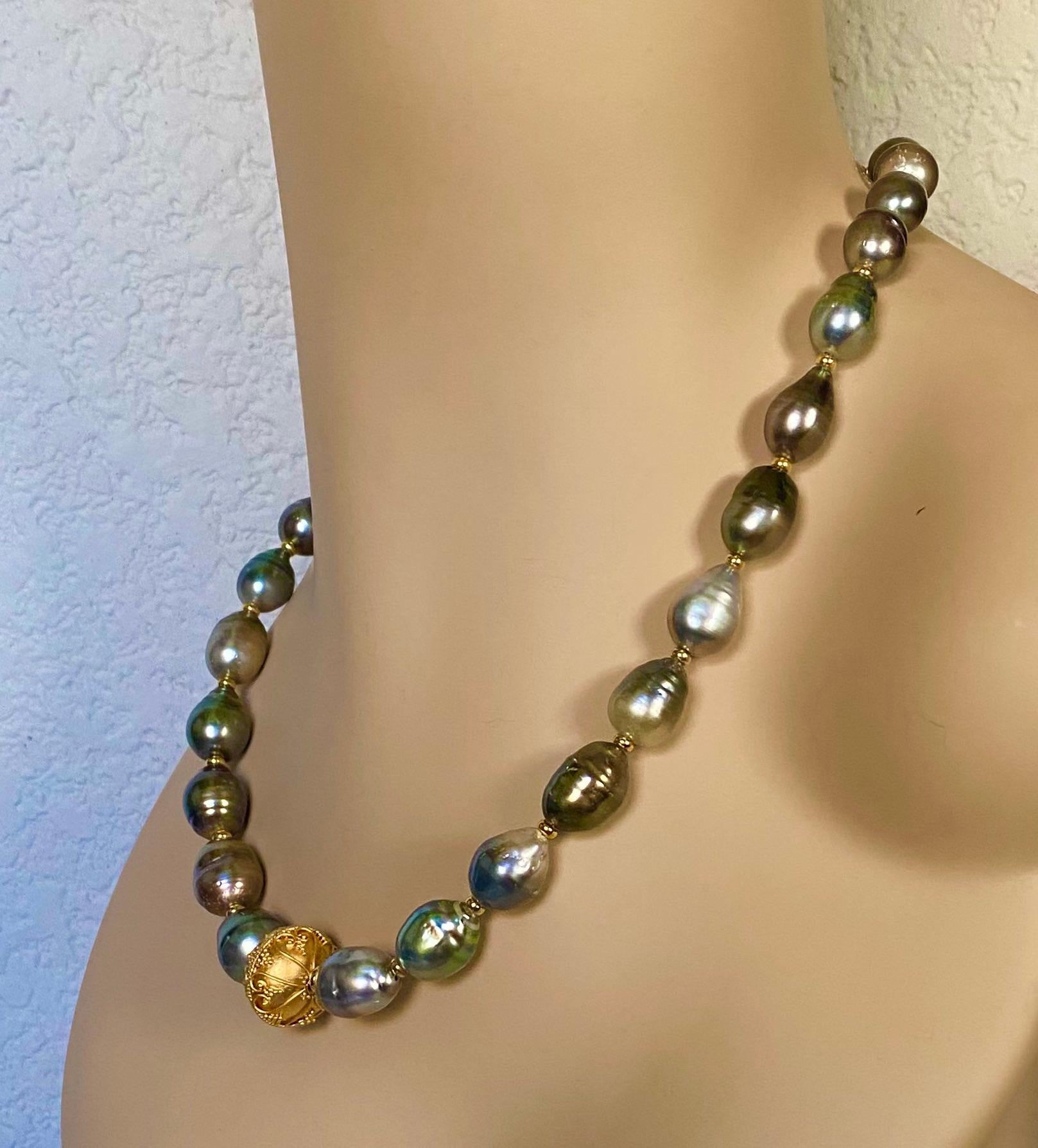 Tahitian pearls are complimented by a single granulated bead in this elegant necklace.  The pearls are referred to as 