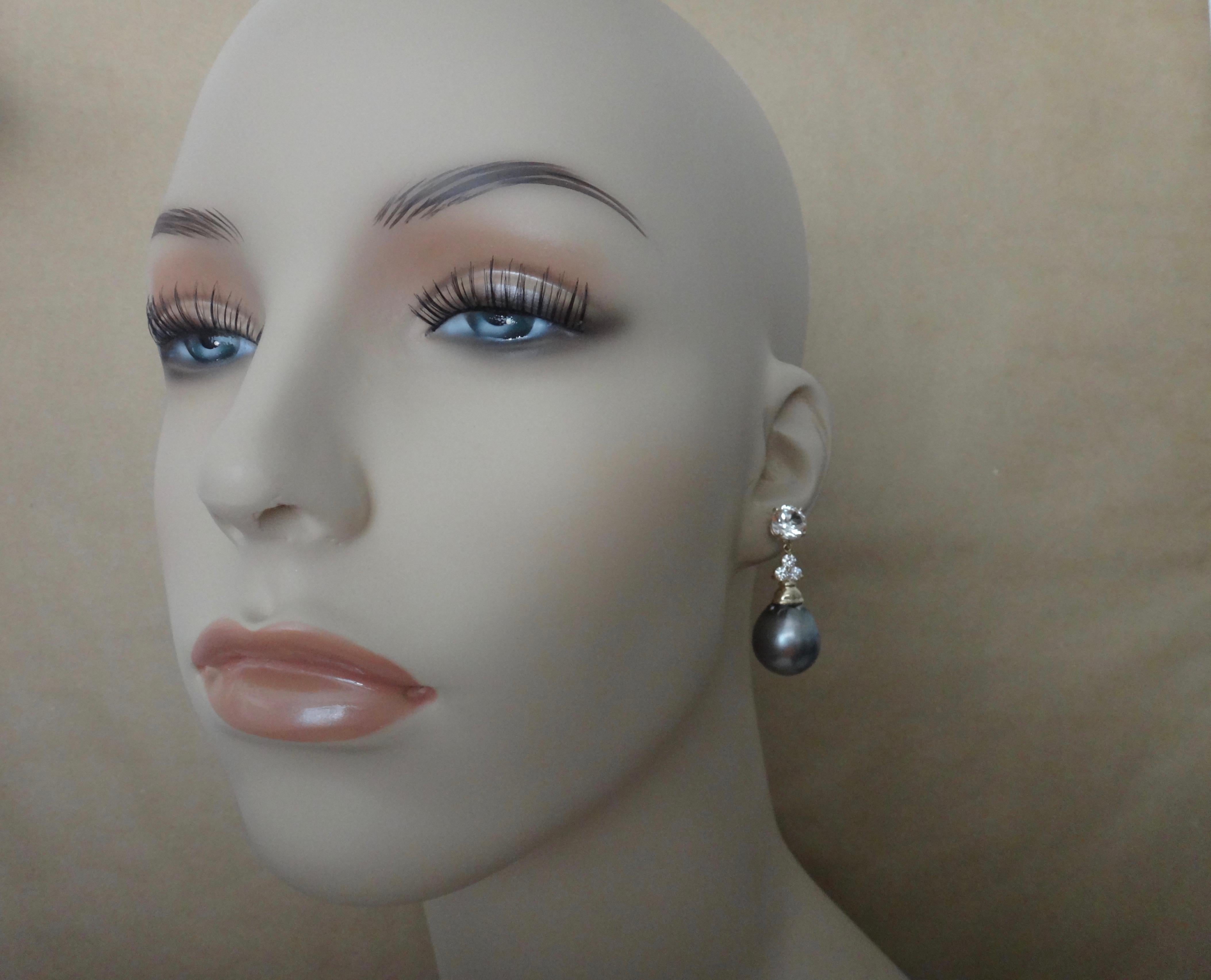 Tahitian pearls along with brilliant cut silver sapphires and white diamonds combine to form these archetypal dangle earrings.  The pear shaped baroque pearls measure a whooping 16mm, are medium gray in color and possess wonderful luster.  The