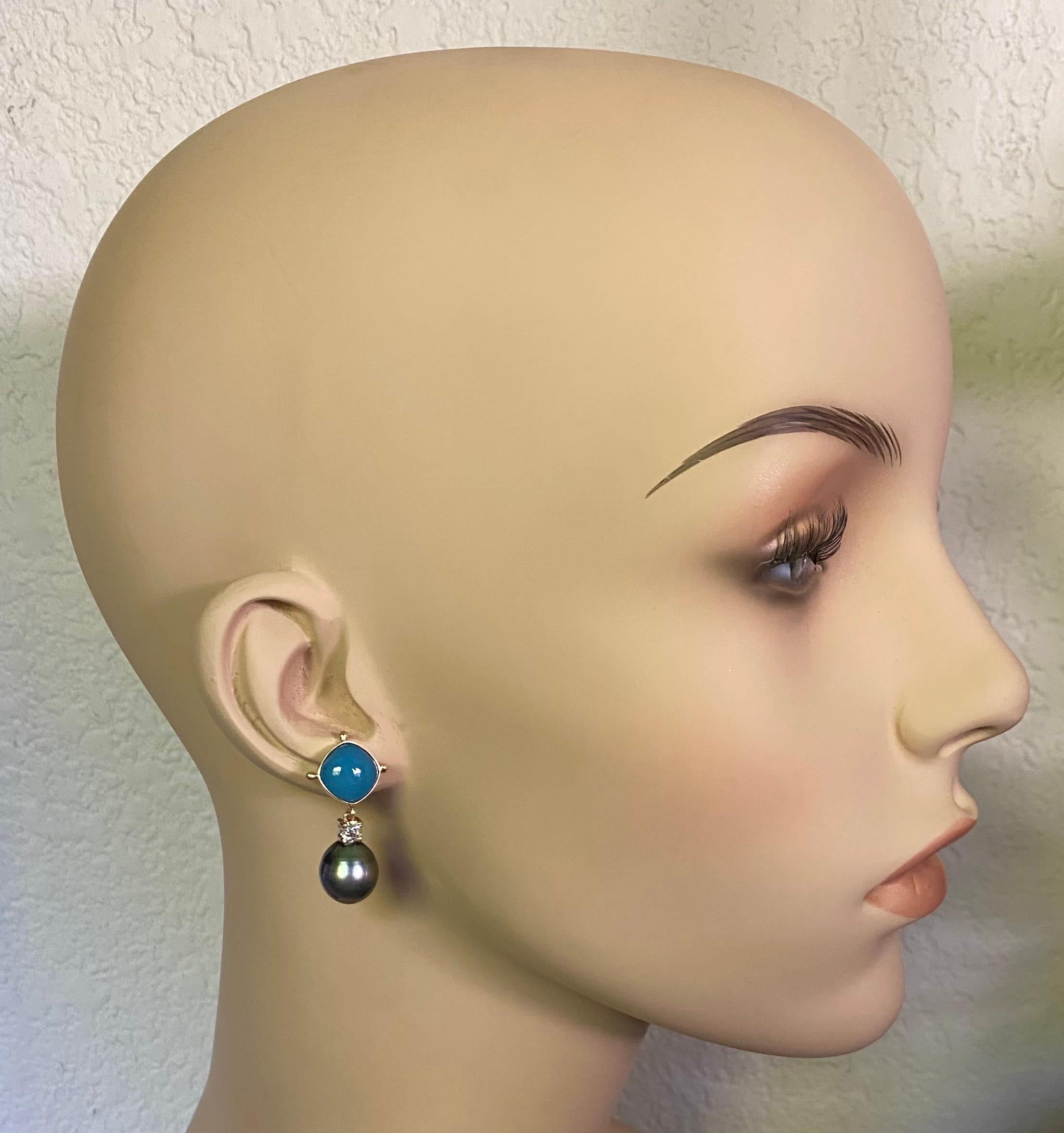 Blue chalcedony is paired with Tahitian pearls is these simply elegant dangle earrings.  The 10 x 10 mm cushion shaped chalcedony are well polished and perfectly matched.  The Tahitian pearls are slightly pear shaped with an iridescent rainbow of