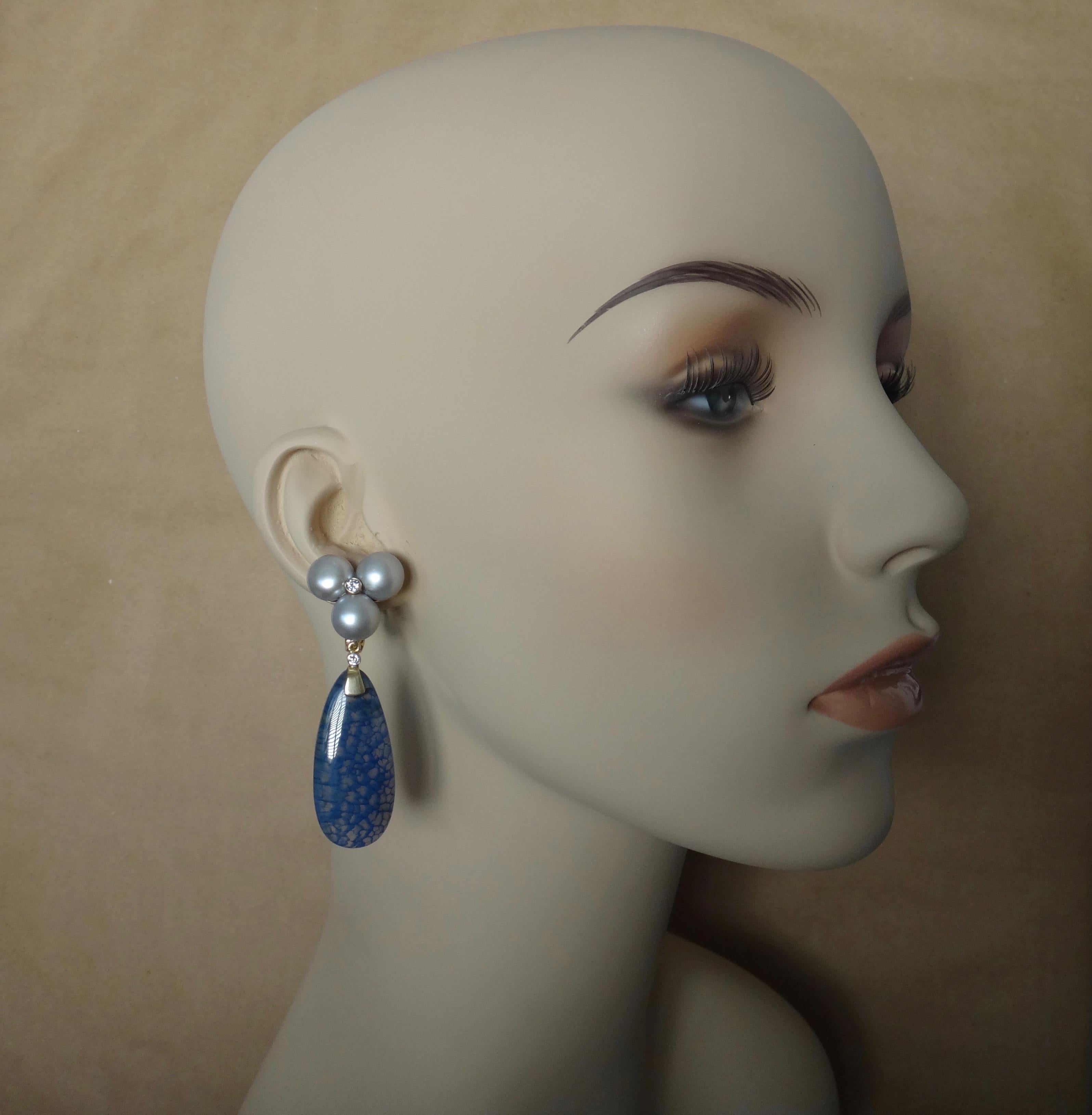 Blue Dragon's Skin agate (origin: China) pendants are removable in these bold dangle earrings.  The blue patterns are evenly distributed across the drops which are well polished and highlighted with a bezel set diamond in each.  The drops hang from