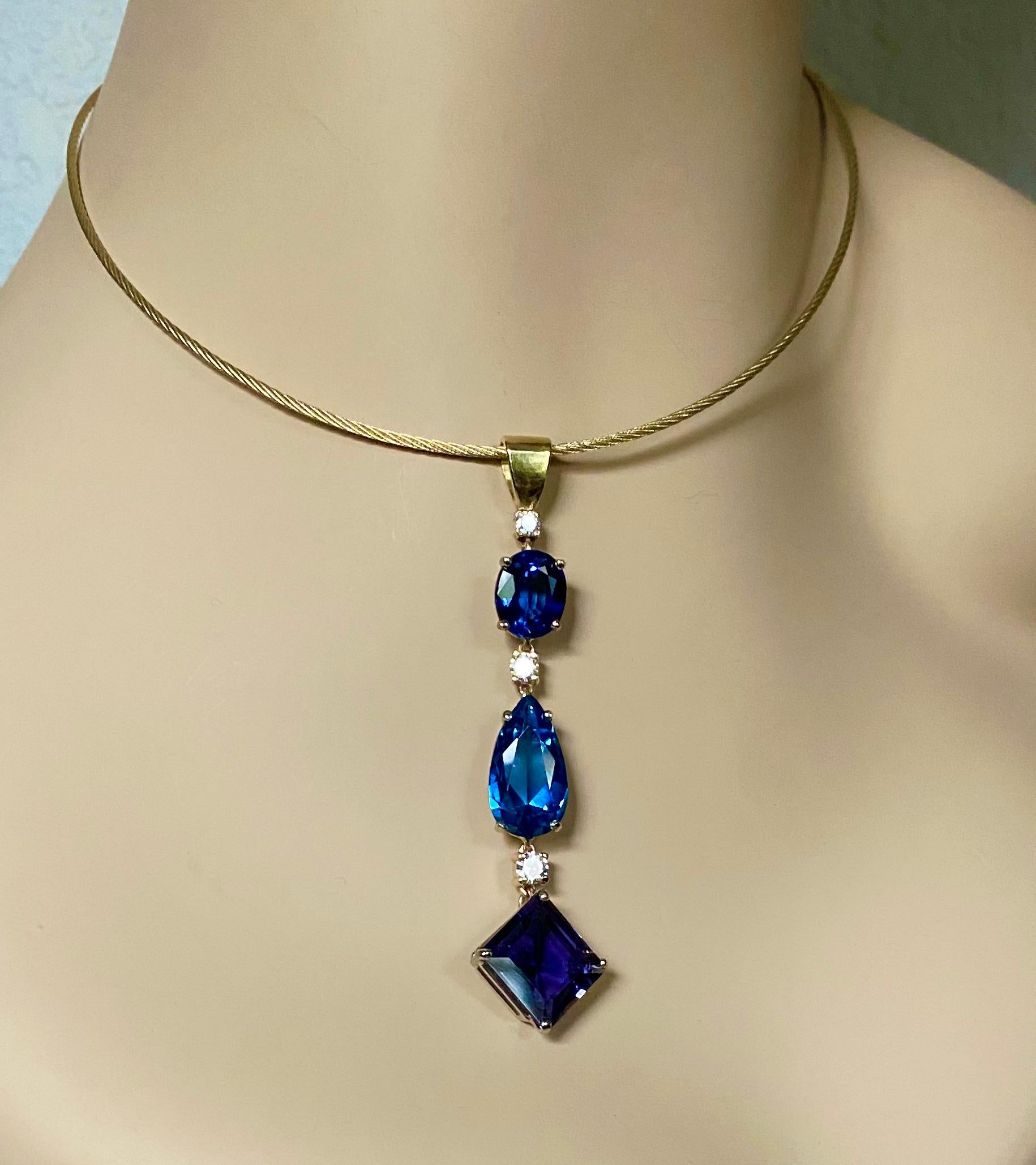 An amalgam of blue gemstones fashions this elegant Stiletto pendant.  Oval shaped blue topaz (origin: Brazil) is followed by a pear shaped apatite (origin: Mexico) and finished with a square cut iolite (origin: Sri Lanka).  All the gems are well cut