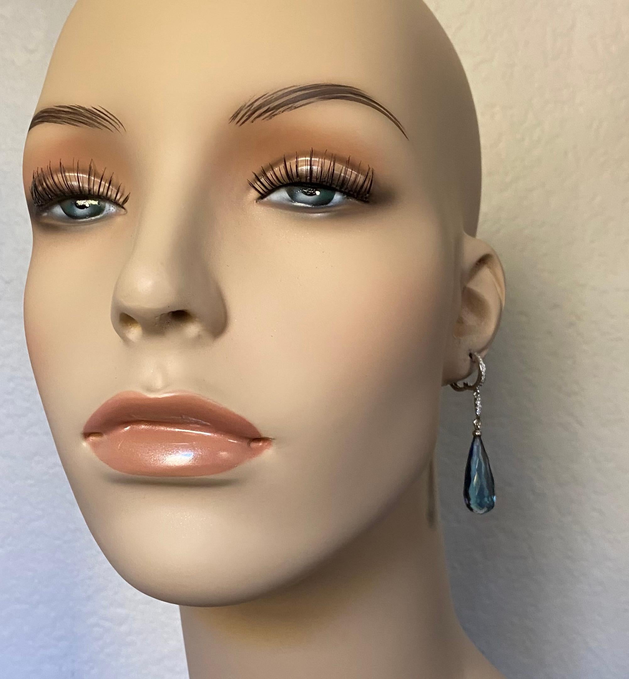Blue topaz in an elongated briolette form are featured in these elegant dangle earrings.  The drops are a lovely sky blue and are very well cut and polished.  The are suspended from micro-pave diamond settings in white gold.  The blue topaz paired
