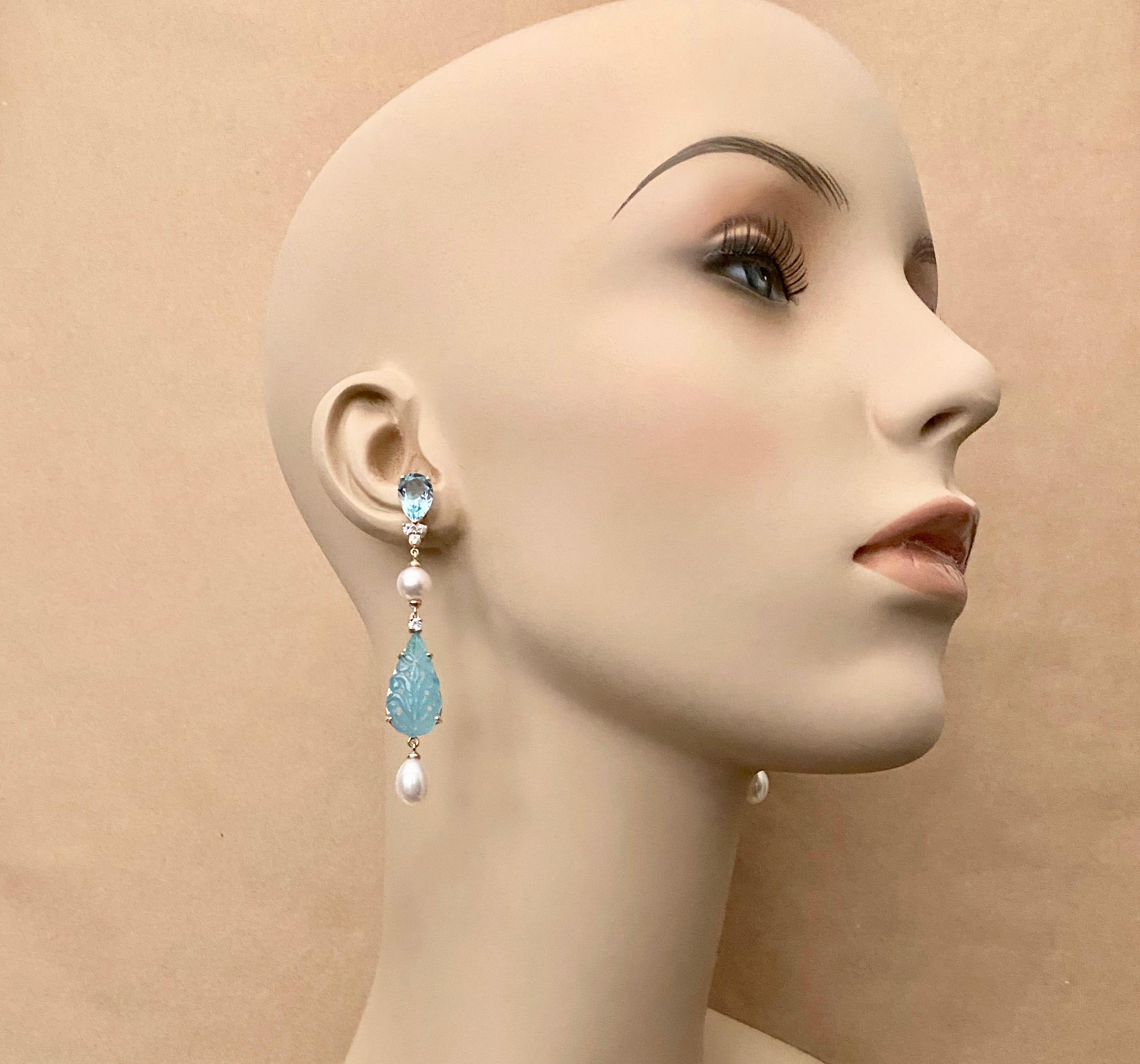 A mixed collection of gems are combined to create these sophisticated dangle earrings.  Faceted pear shaped sky blue topaz (origin: Brazil) compliment carved baby blue chalcedony drops (origin: Brazil).  The floral carving is exquisite and in the
