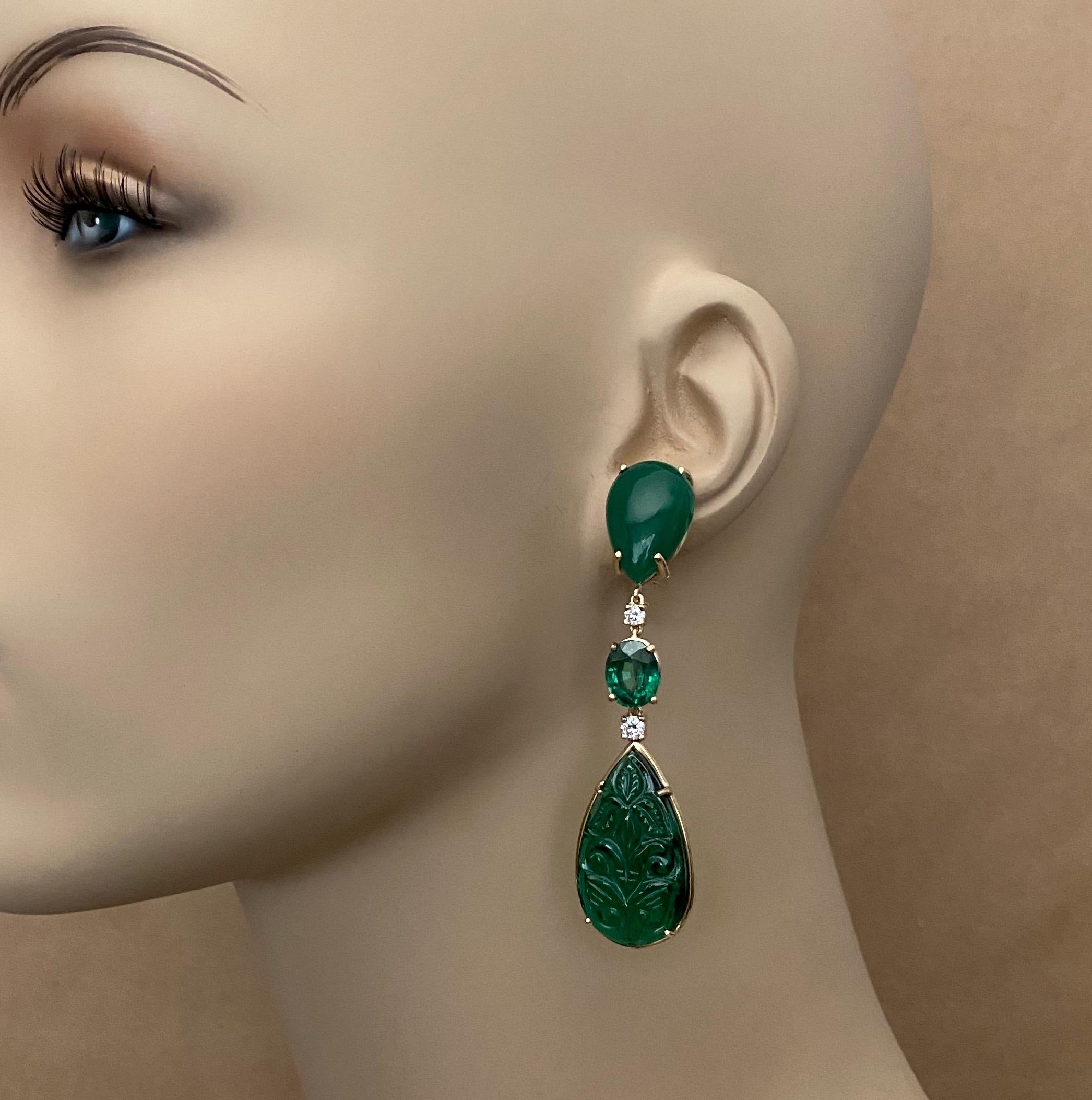 A composition of green tones comprise these dramatic dangle earrings.  Pear shaped and cabochon cut Botswana agate begins the decent with white diamonds, and oval cut green topaz.  Finally a pair of green onyx complete this harmonious blend.  The