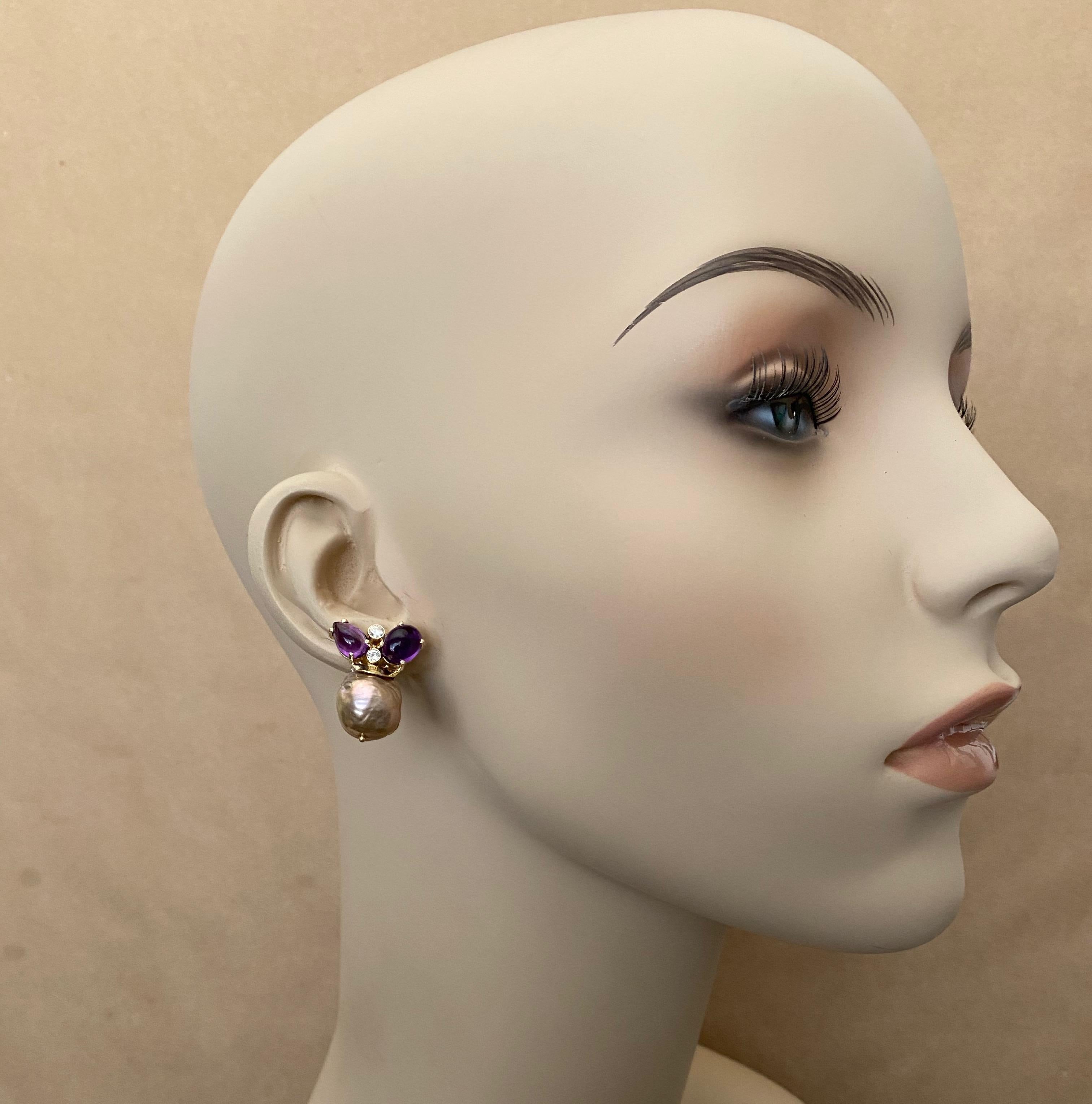 A cluster of cabochon amethyst, brilliant cut diamonds and baroque Japanese pearls combine to form these elegant drop earrings.  The oval and pear shaped amethyst are flawless, are a rich purple color and are well polished.  The pearls are an