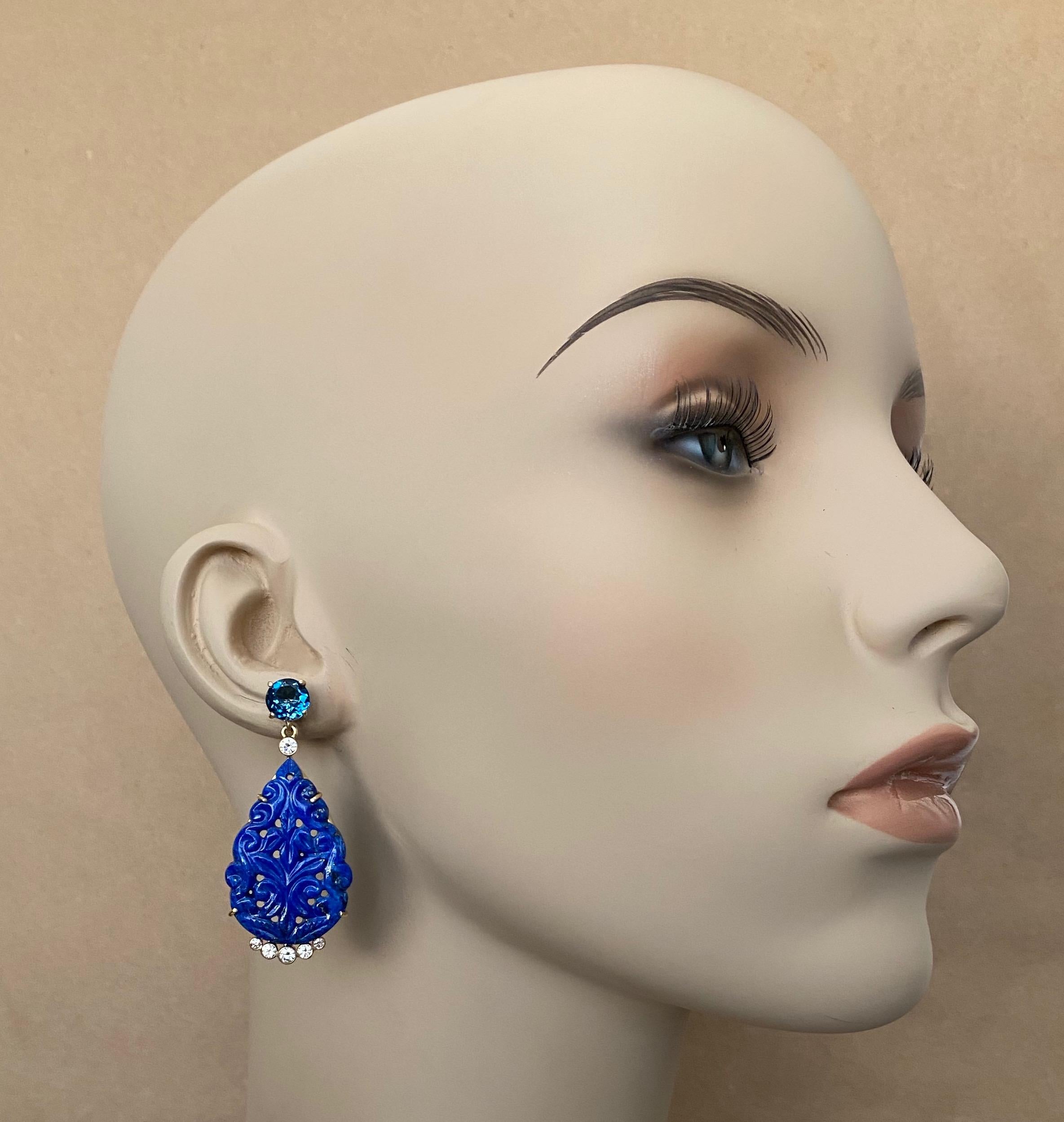 Lapis Lazuli is paired with London blue topaz in these exotic dangle earrings.  The plaques are exquisitely carved in an Indian influenced floral design.  The lapis (origin: Afghanistan) is bright blue with some pyrite flecks typically found in the
