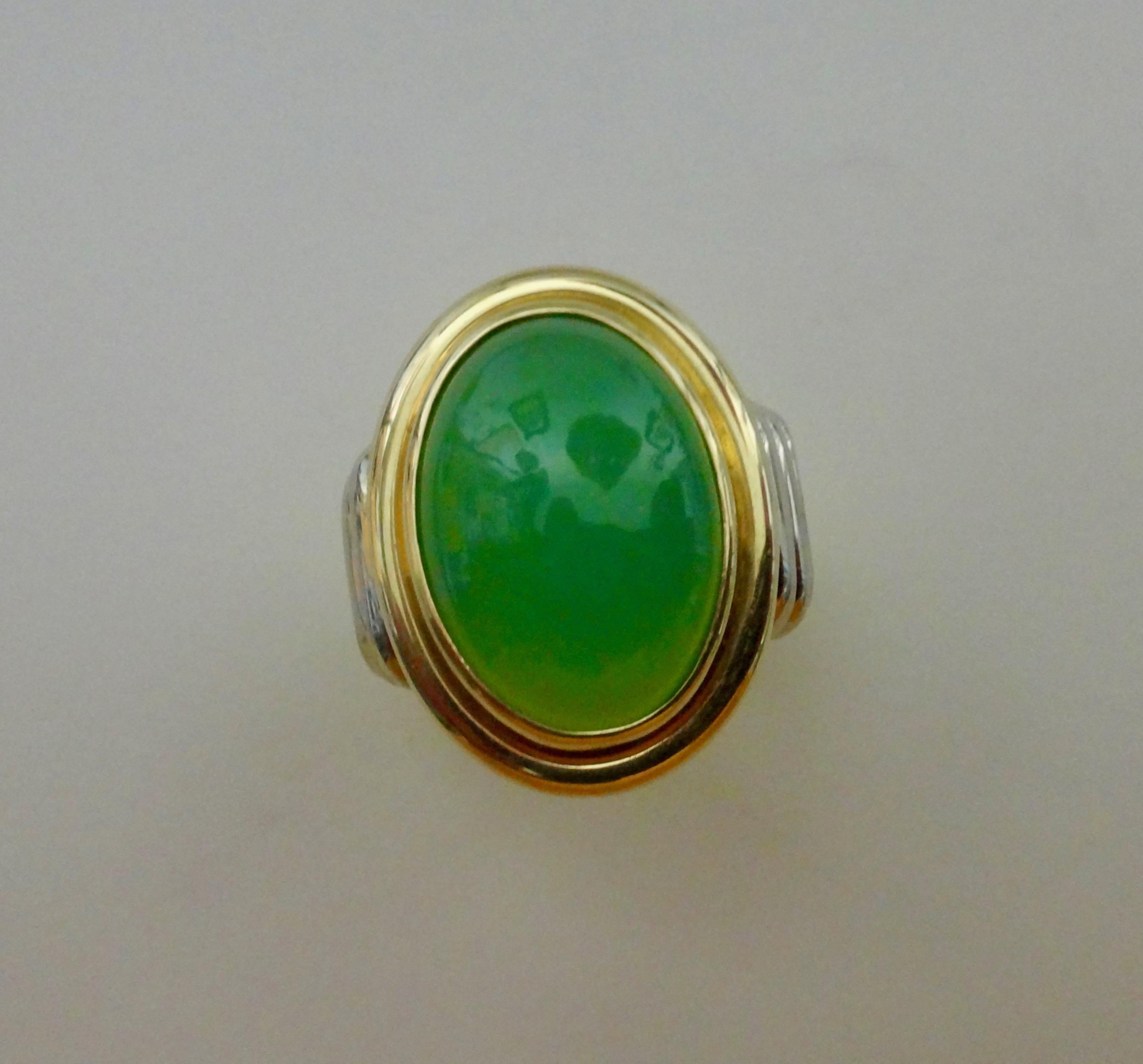 A gem quality chrysoprase (origin: Australia) is set in a hand fabricated 18k yellow and white gold ring.  The bezel set gem is a rich apple green and possesses a flawless finish.  The ribbed design of the shank keeps ware to a minimum.  The ring is