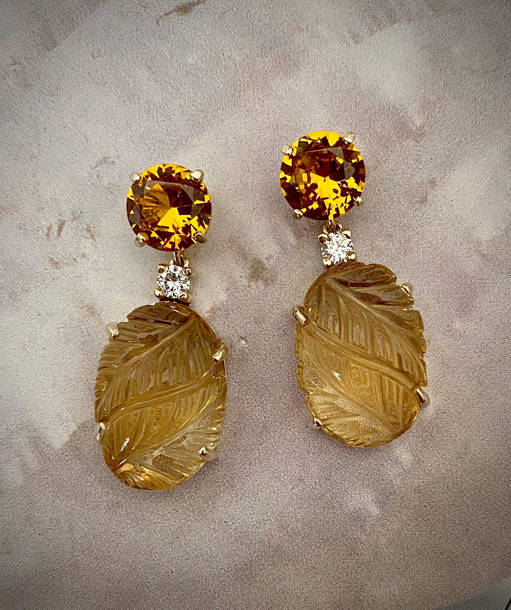 Citrine and diamonds are presented in these one of a kind dangle earrings.  The citrine cabochon pendants are exceptionally carved in faraway India in a yin yang leaf design.  The gems are complimented by dazzling brilliant cut citrines (origin: