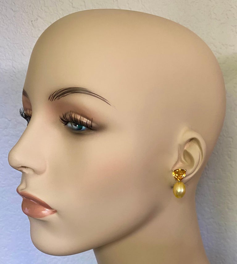 Trillion cut citrines are paired with golden South Seas pearls in the versatile drop earrings.  The citrines are expertly cut and polished to a dazzling finish.  The gem quality and perfectly matched pear shaped pearls are a buttery yellow/gold.