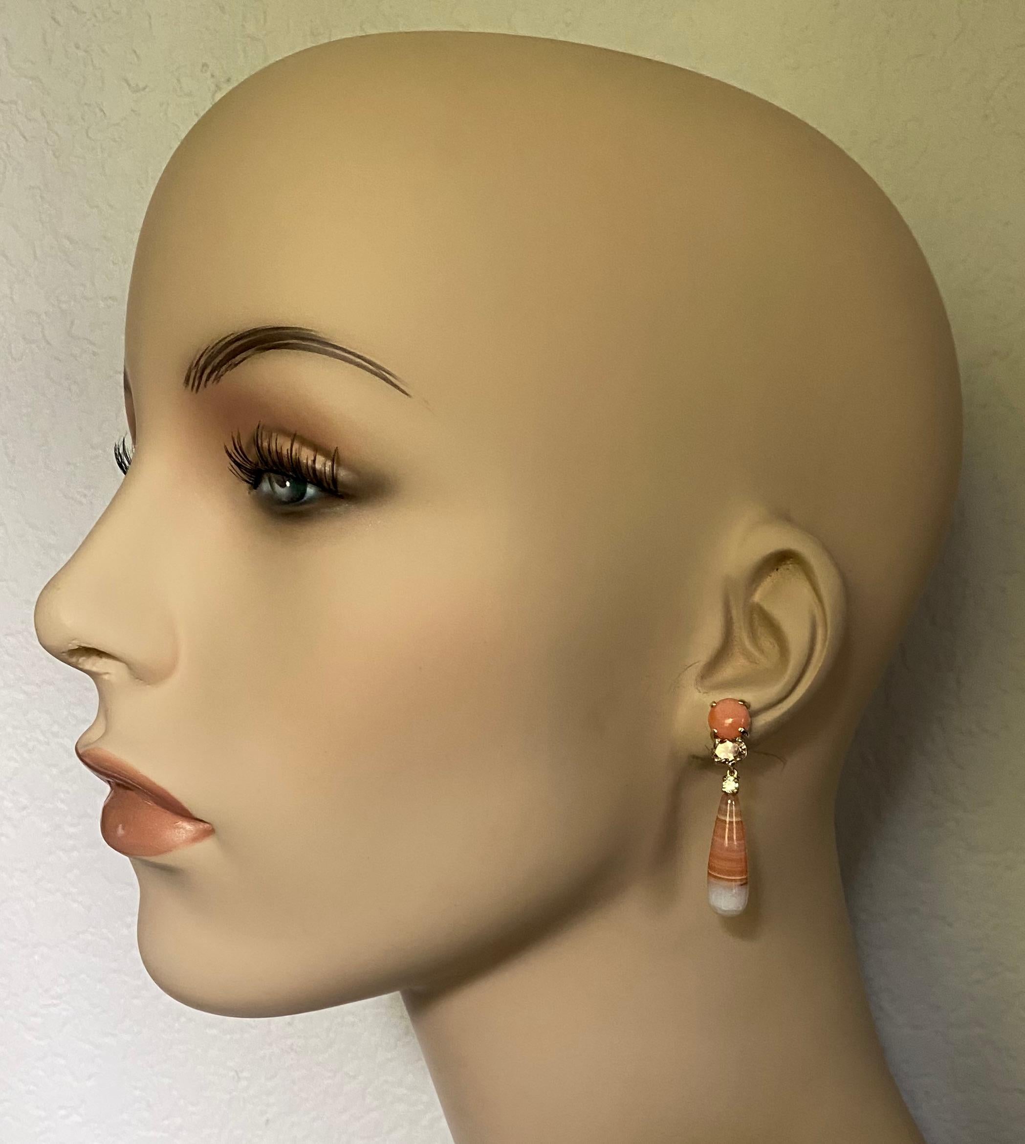 Angel skin coral, Morganite, diamond and banded chalcedony agate form these delicate dangle earrings.  The coral (origin: Japan) is a rich peach color with a glass-like polish.  The Morganite (origin: Brazil) is the peach version of the larger beryl