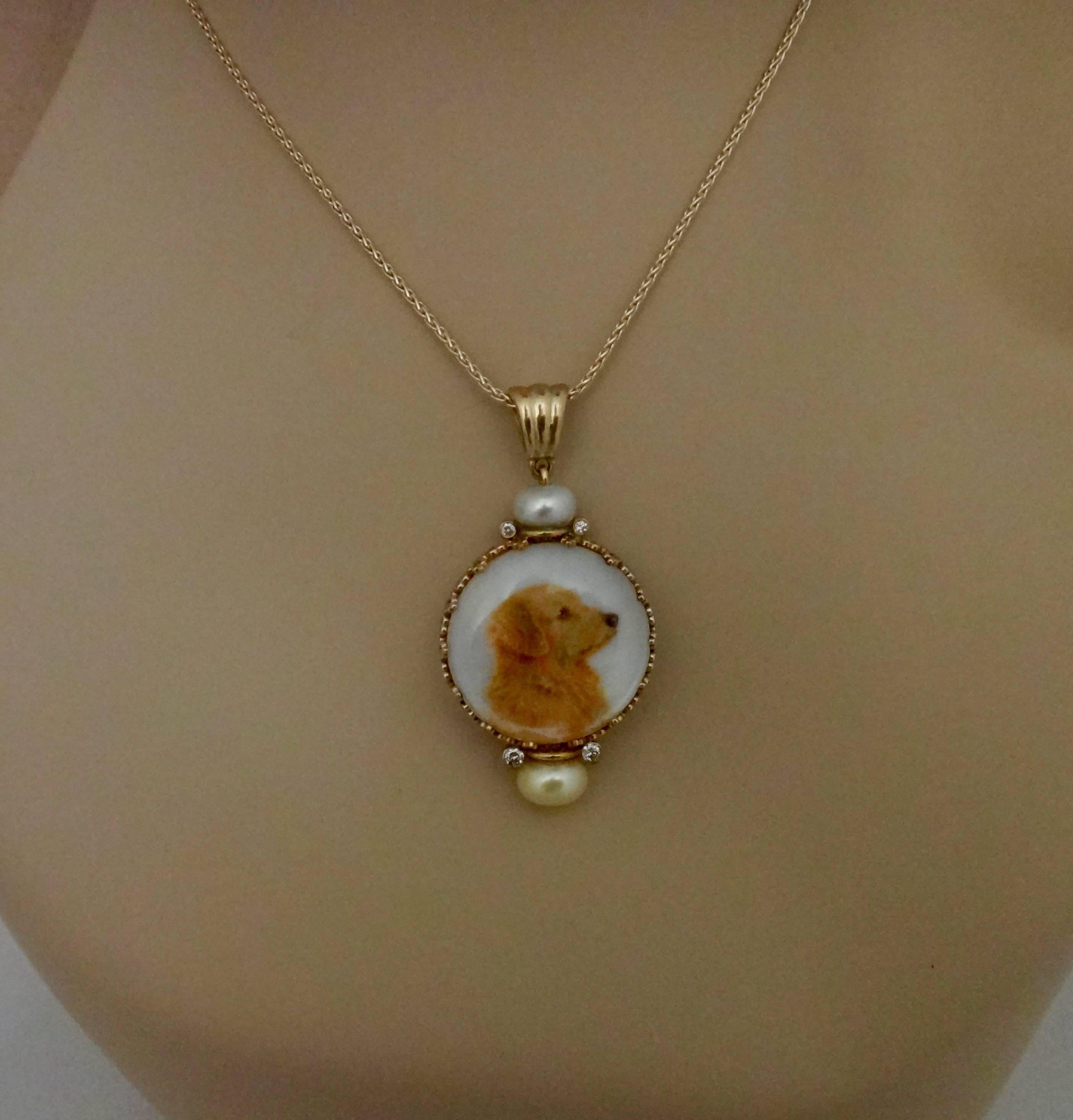 A miniature portrait of a golden retriever is featured in this one-of-a-kind pendant.  The oil on mother-of-pearl painting is by artist Georgina Love.  The painting is protected by a rock crystal lenses, is set in gold and decorated with golden and