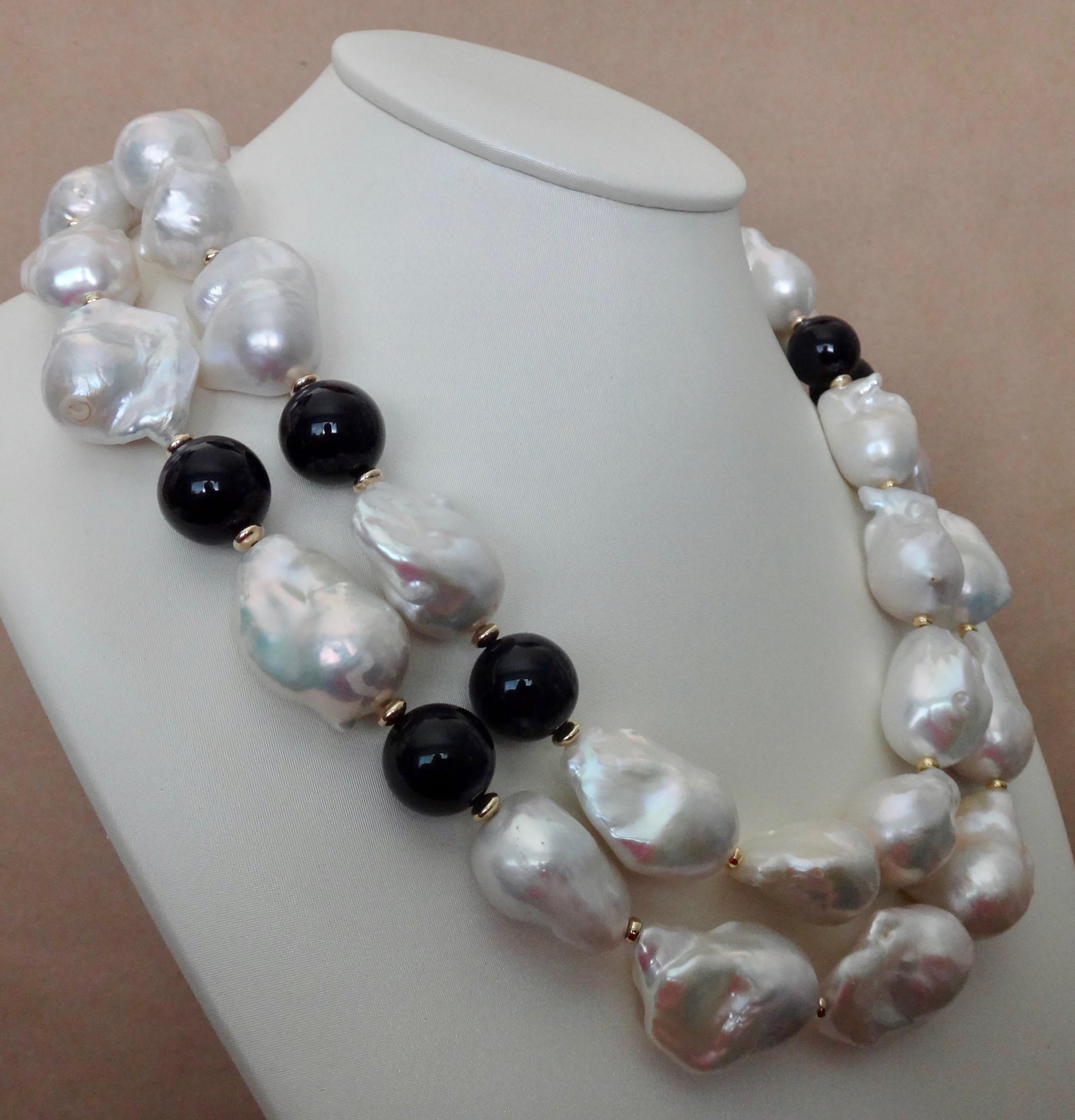 Two strands of enormous baroque Chinese freshwater pearls and black onyx beads comprise this dramatic necklace.  The pearls are graduated in size.  The largest measures 32mm.  Baroque pearls are so casual and easy to dress up or down.  The design