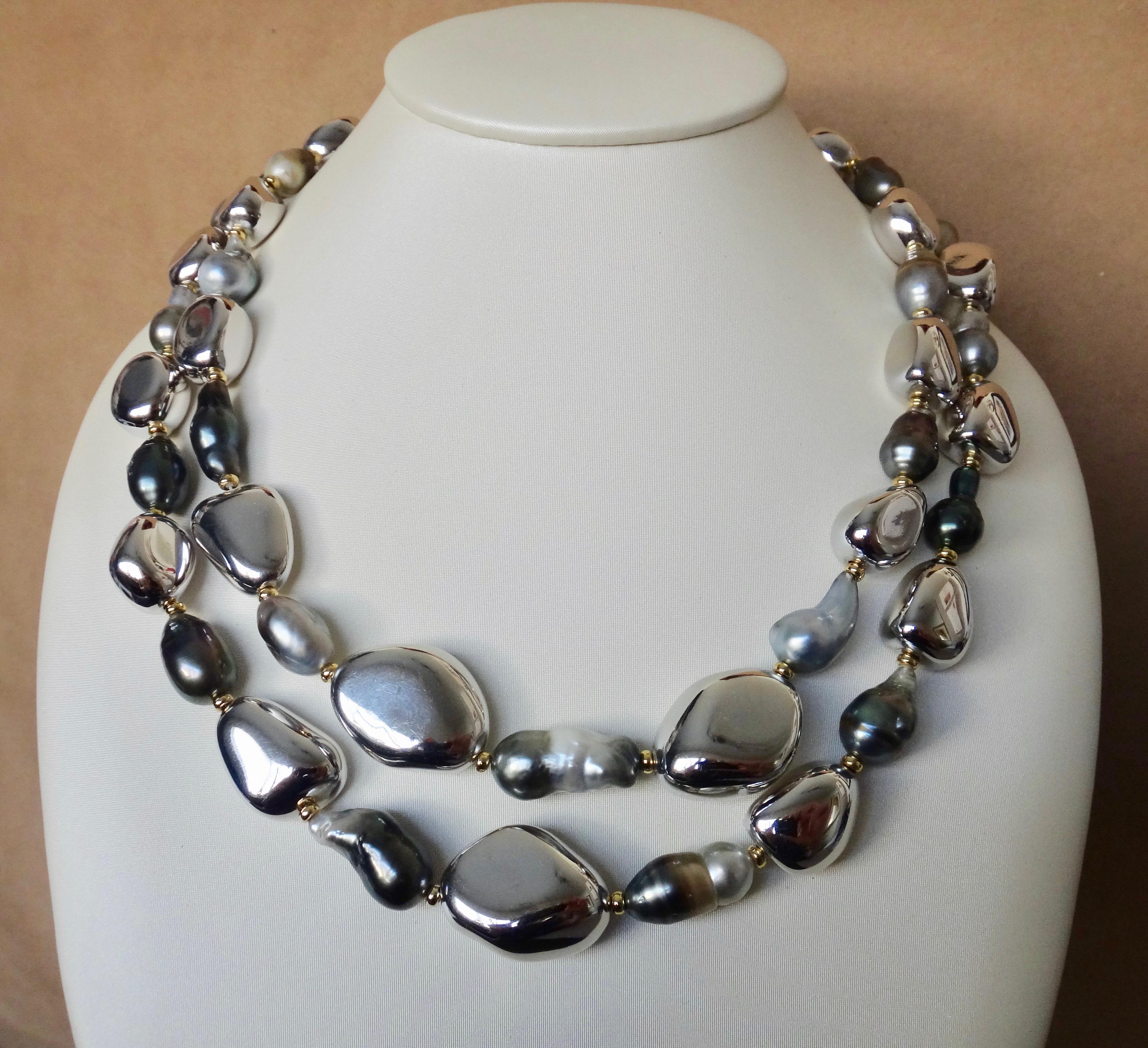 Baroque Tahitian pearls are paired with sliver pebble beads is this bold yet casual necklace.  The collection of multi-colored pearls range from nearly white to black, sometimes within the same pearl.  They possess beautiful luster.  The handmade