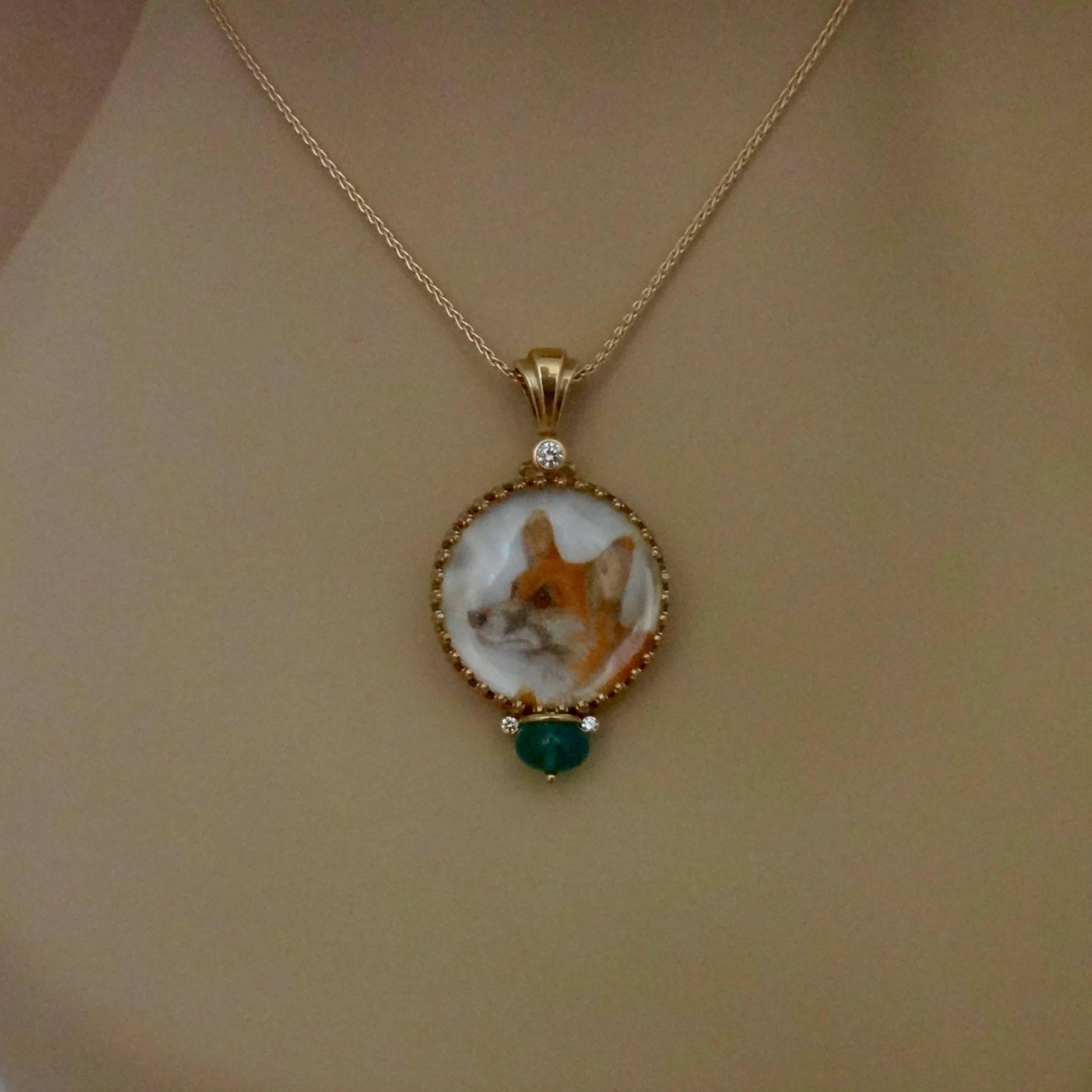 A miniature oil painting of a Welsh Corgi is featured in this one-of-a-kind portrait pendant.  The oil on mother-of-pearl is painted by artist Georgina Love.  The painting is covered by a rock crystal lenses, is set in a filigree gold frame and
