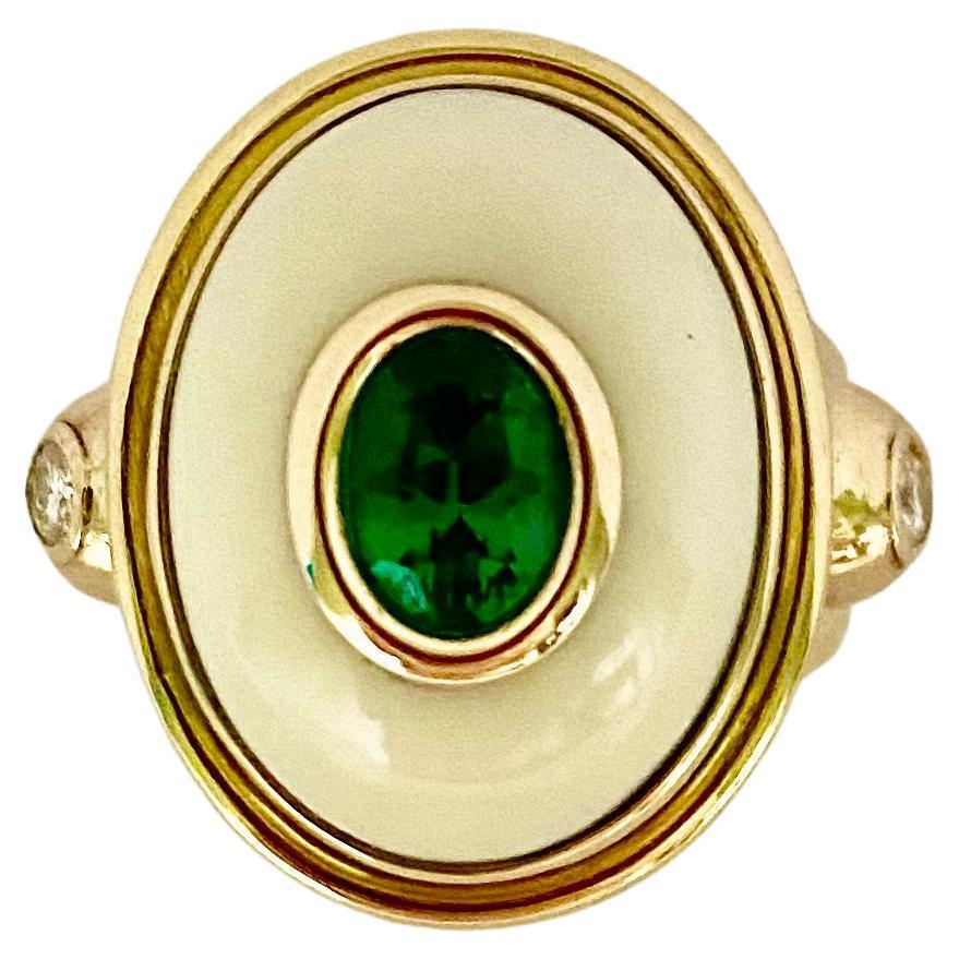 Emerald is set within a white coral cabochon in this archaic style ring.  The oval shaped emerald (origin: Zambia) is of exceptional color, cut and quality.  The gem is bezel set atop a fine creamy white coral cabochon (origin: Japan).  The ring is