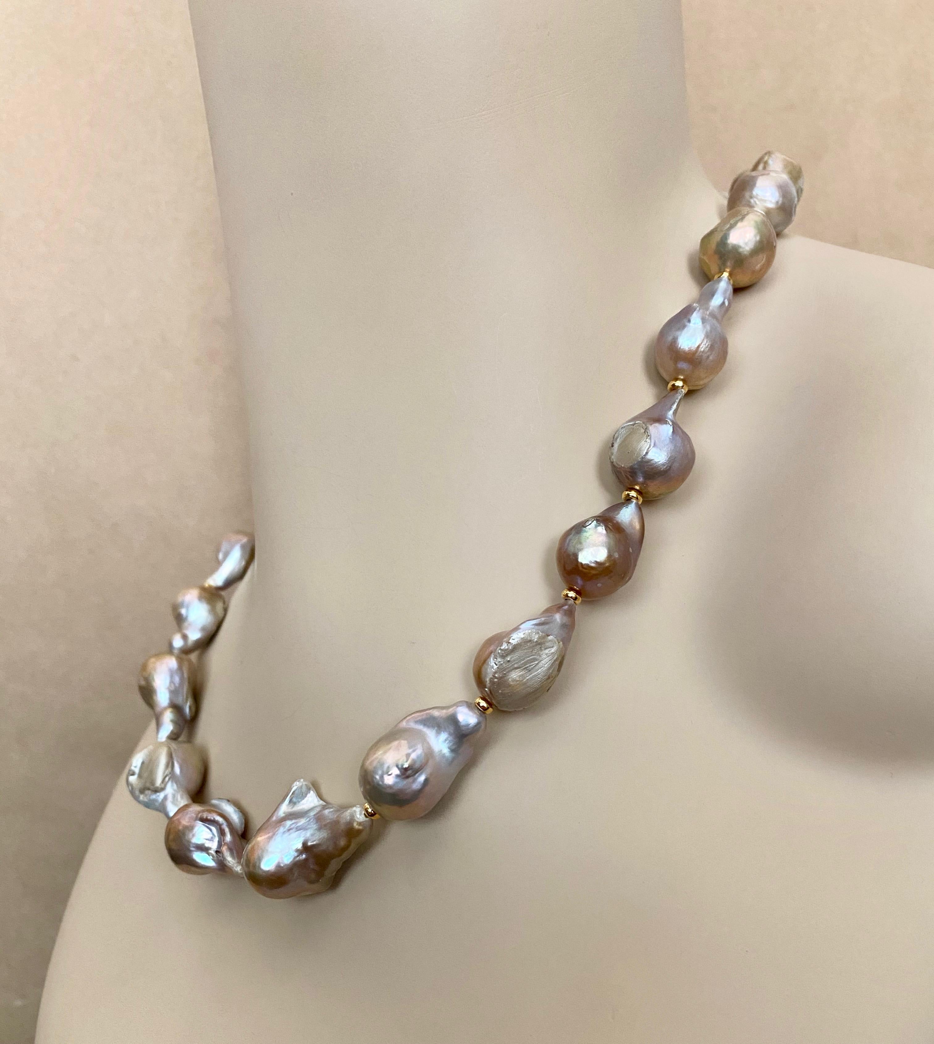 Flame Ball pearls (origin: China) comprise this chic pearl necklace.  The pearls are gray in color with rose tones.  They are very baroque in shape and have beautiful luster.  The pearls are spaced with small gold beads and come with a hammered