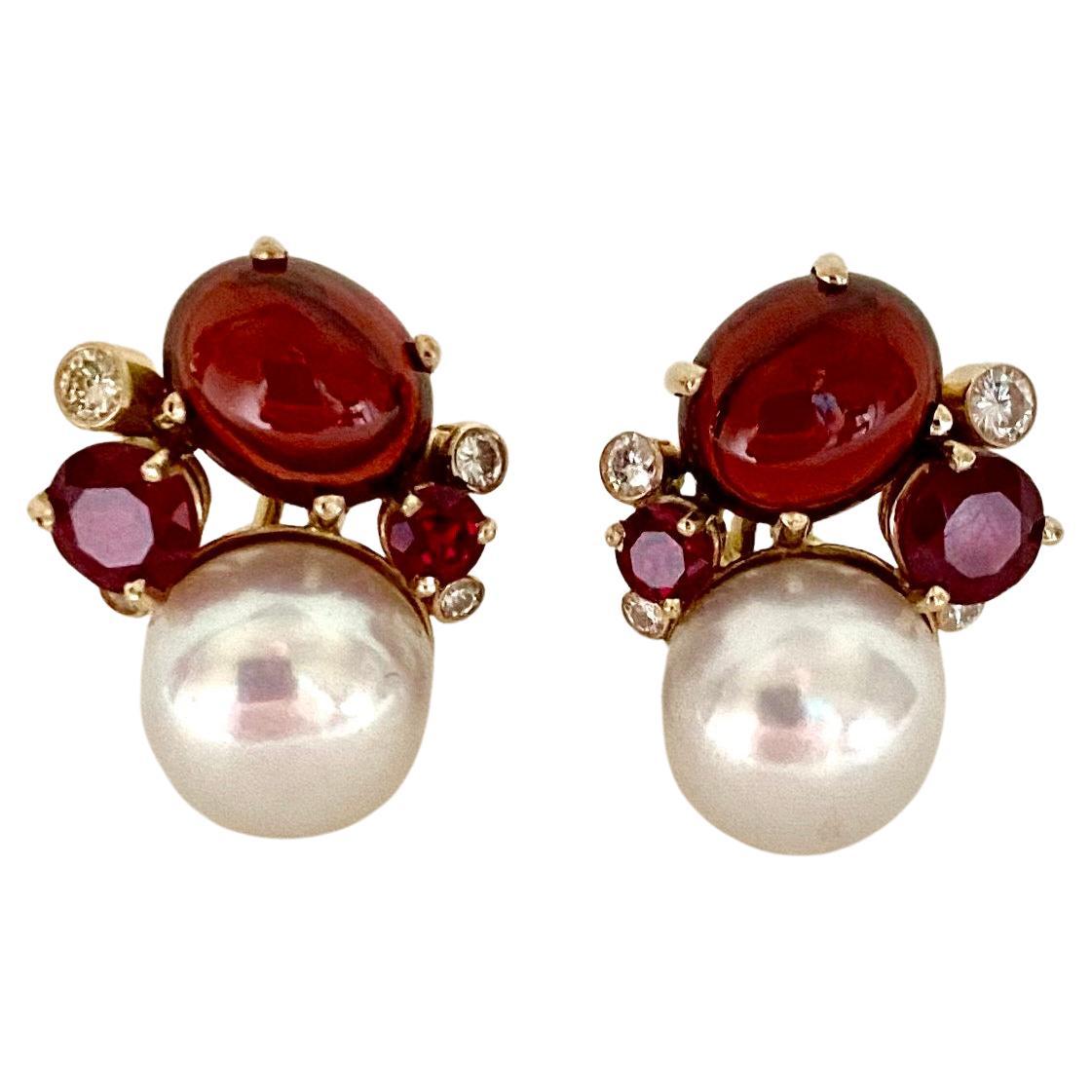 Red gems are clustered together along with white pearls to create these Confetti earrings.  Mixed together are cabochon garnets (origin: Mozambique) with faceted rubies (origin: Thailand), white diamonds and 12mm freshwater pearls.  The gems are all